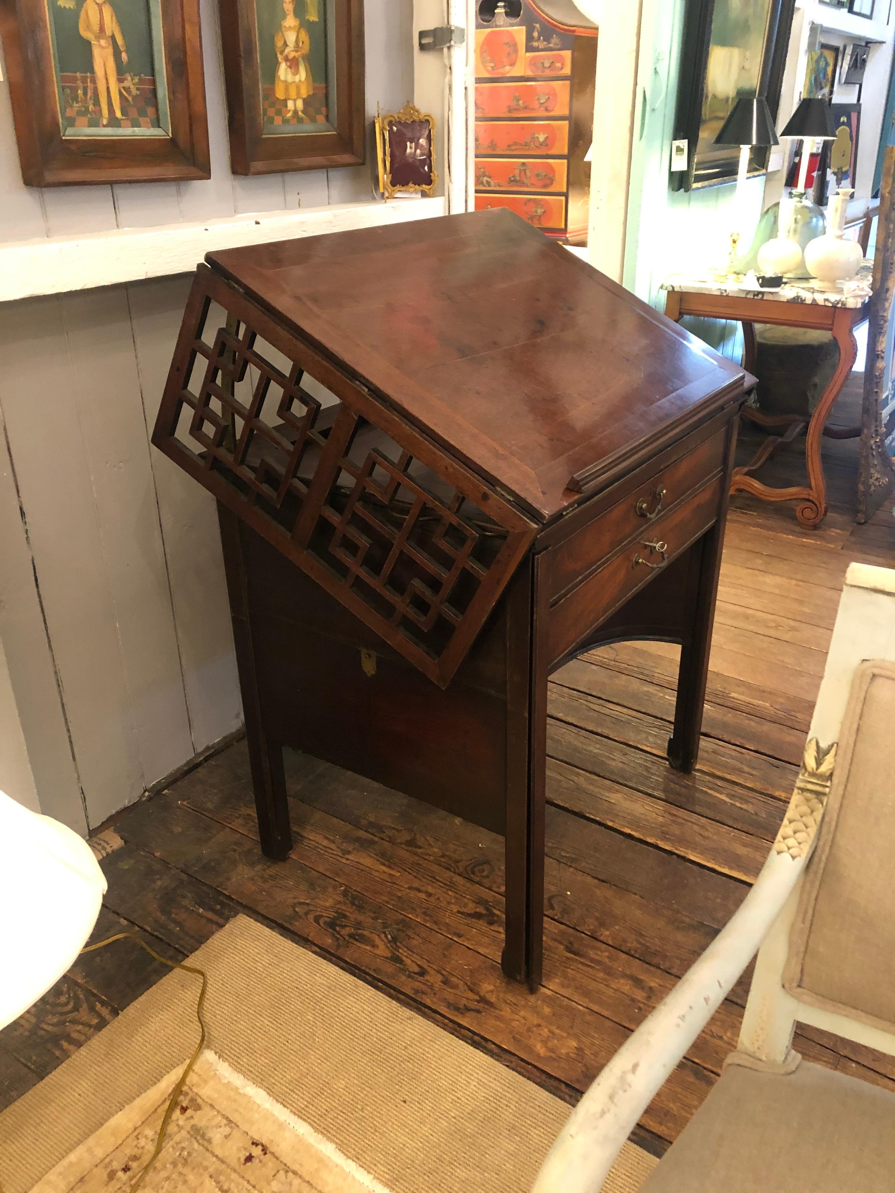 Marvelously designed versatile architect's desk that can be used as an elegant console with fretwork drop leaves, as a lecturn for an important book in a library, or as a functional work station architect's desk. The top of the table can be elevated