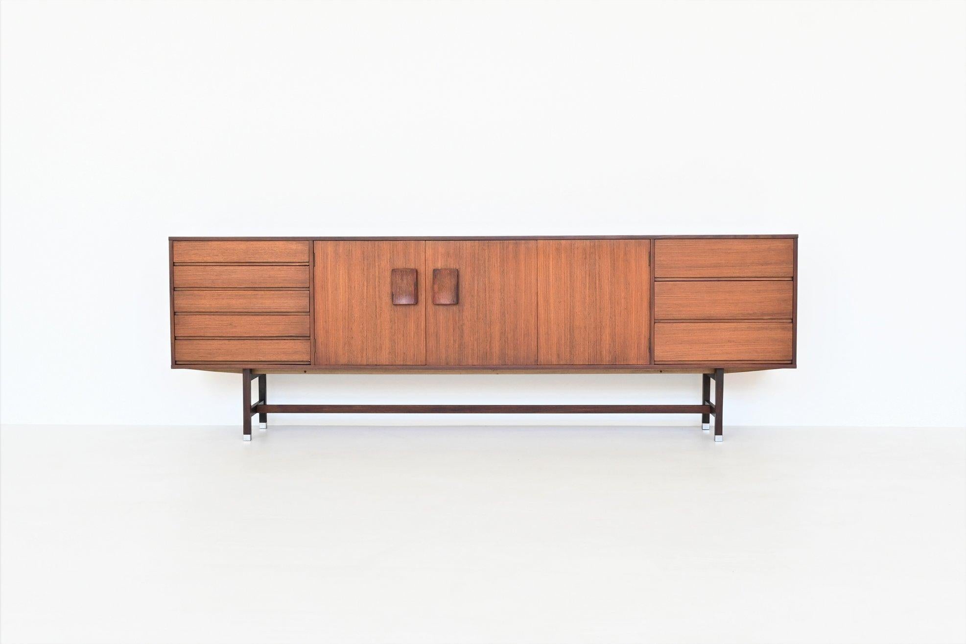 Beautiful sleek shaped sideboard designed by Inger Klingenberg for Fristho Franeker, The Netherlands 1960. This sideboard is made of nicely grained rosewood veneer supported by a solid rosewood frame with aluminium feet. It has three doors with