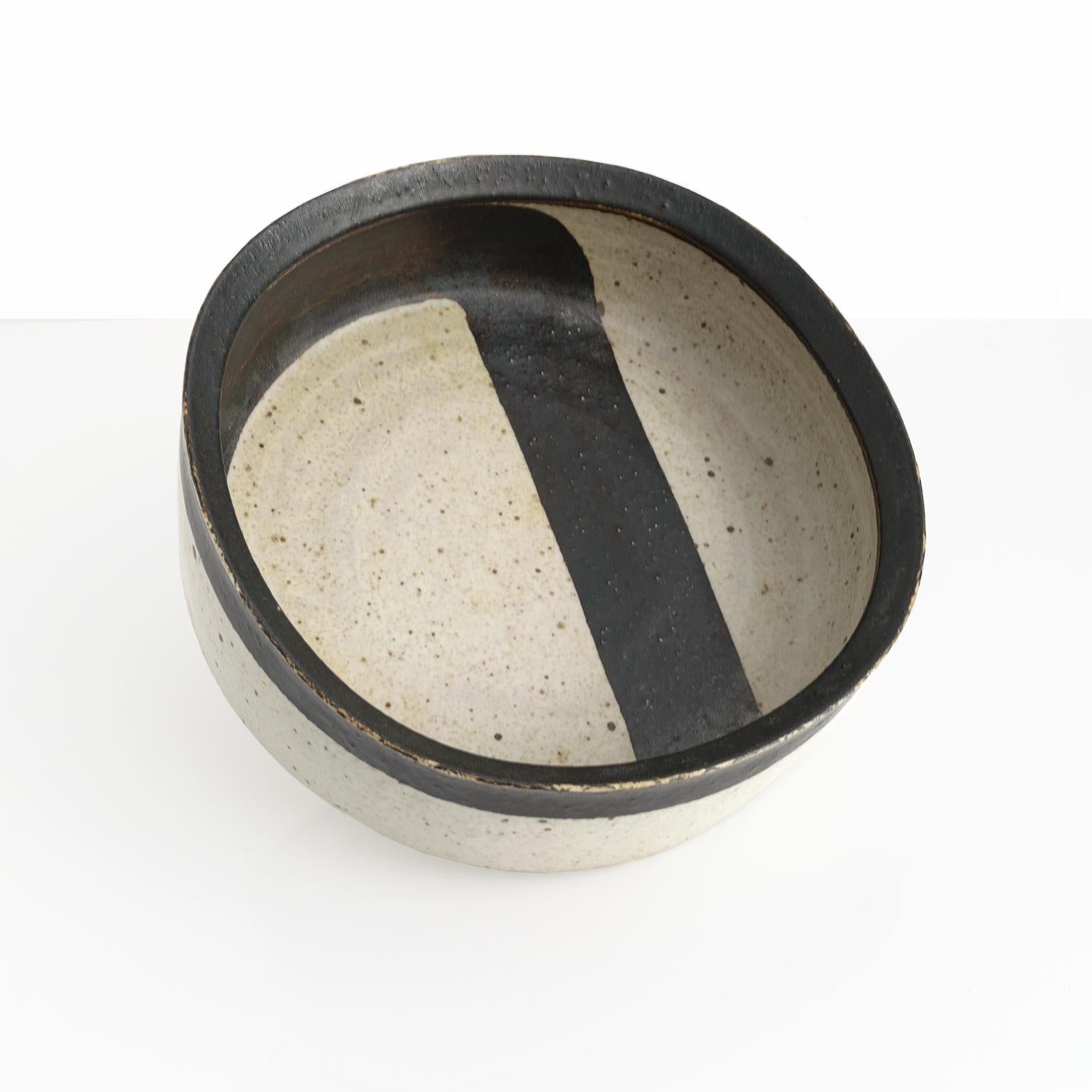 Inger Persson designed this bold graphic ceramic studio bowl in the 1960’s for Rorsrand, Sweden. This piece has a slightly squared shape, with a dark brown to black hand painted band against an off white ground. 

Measures: Diameter 12” Heigth 4”.