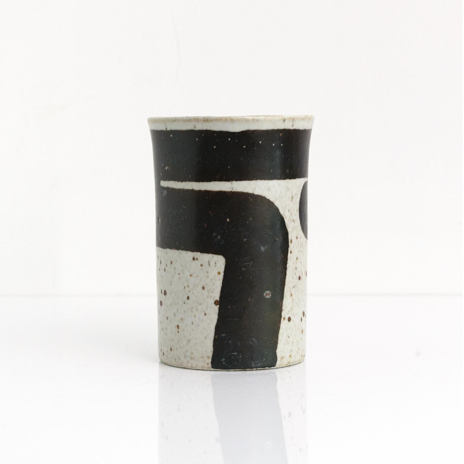 Inger Persson designed this bold graphic ceramic studio vase in the 1960’s for Rorstrand, Sweden. The vase has a slightly squared shape, with a dark brown to black hand painted band against an off white ground. 

Measures: Height 6.25” x Diameter