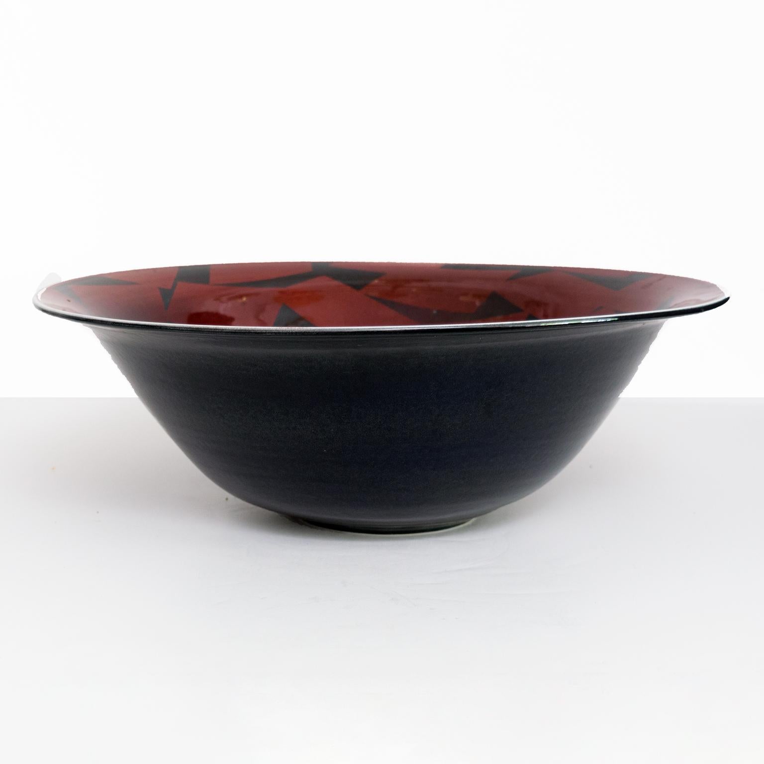 Large Inger Persson porcelain unique Rorstrand studio bowl outer glazed in black and interior in a deep red with decor of angular shapes in black, Signed on bottom and dated 1988. Scandinavian Modern

Measures: Diameter 18.25”, height: 6.5.