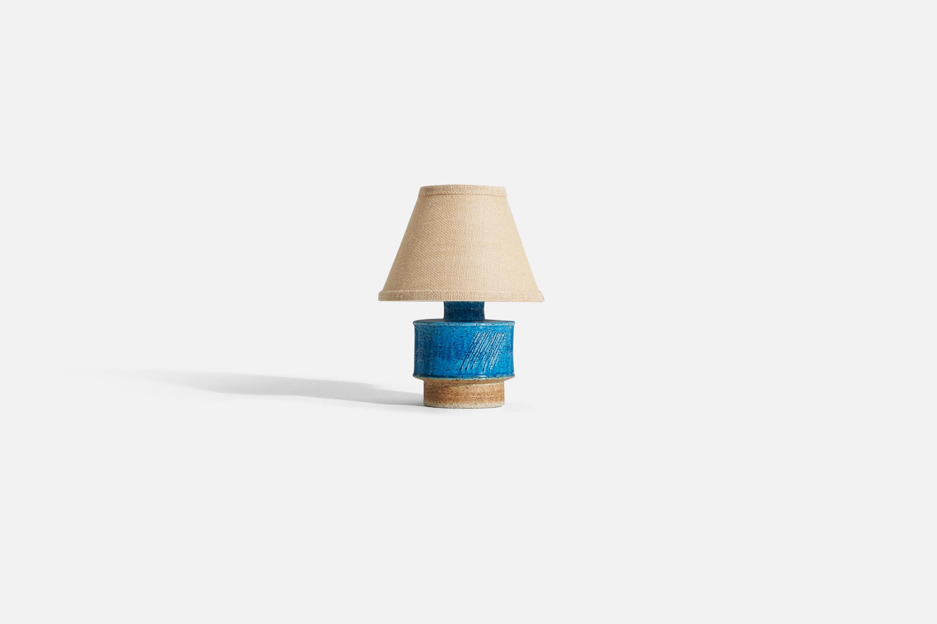 A blue glazed stoneware table lamp designed by Inger Persson, produced by Rörstrand c. 1960s

Sold without lampshade. 

Dimensions of lamp (inches) : 8 x 5 x 5 (H x W x D)
Dimensions shade (inches) : 4.25 x 8.25 x 6 (T x B x H)
Dimension of