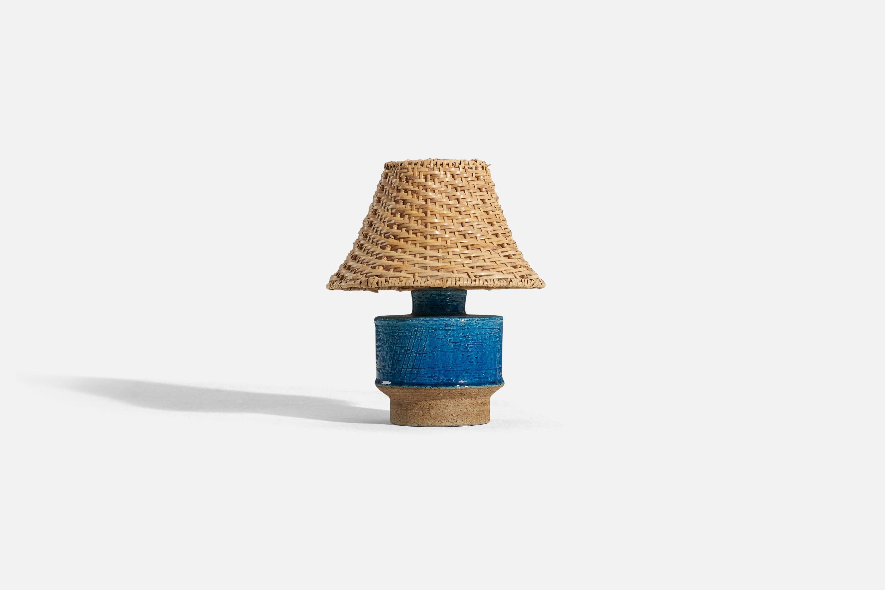 A blue, glazed stoneware table lamp designed by Inger Persson and produced by Rörstrand, Sweden, c. 1960s.

Sold without lampshade. 
Dimensions of Lamp (inches) : 7.625 x 5.0625 x 5.0625 (H x W x D)
Dimensions of Shade (inches) : 4 x 8.75 x 5.5