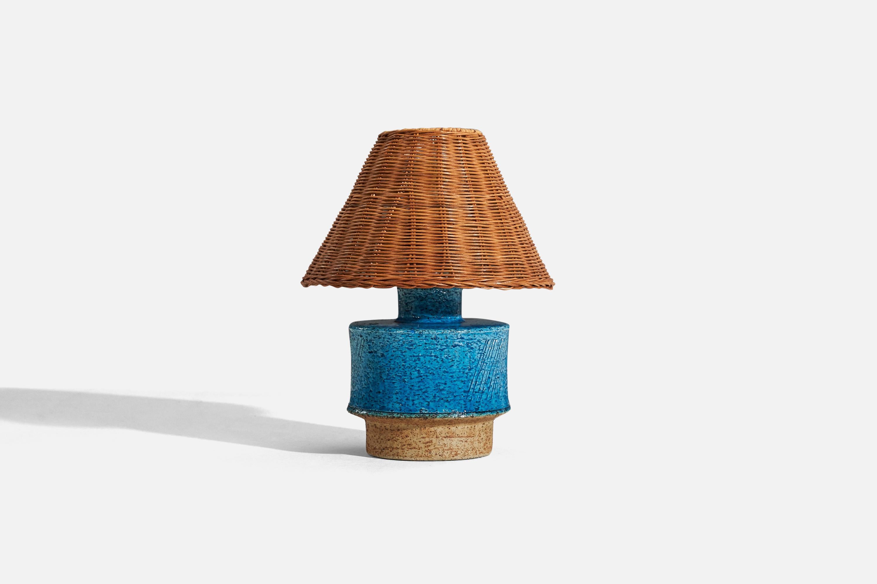 A blue, glazed stoneware table lamp designed by Inger Persson and produced by Rörstrand, Sweden, c. 1960s.

Sold without lampshade. 
Dimensions of Lamp (inches) : 7.75 x 5.25 x 5.25 (H x W x D)
Dimensions of Shade (inches) : 5.875 x 8.25 x 3.5