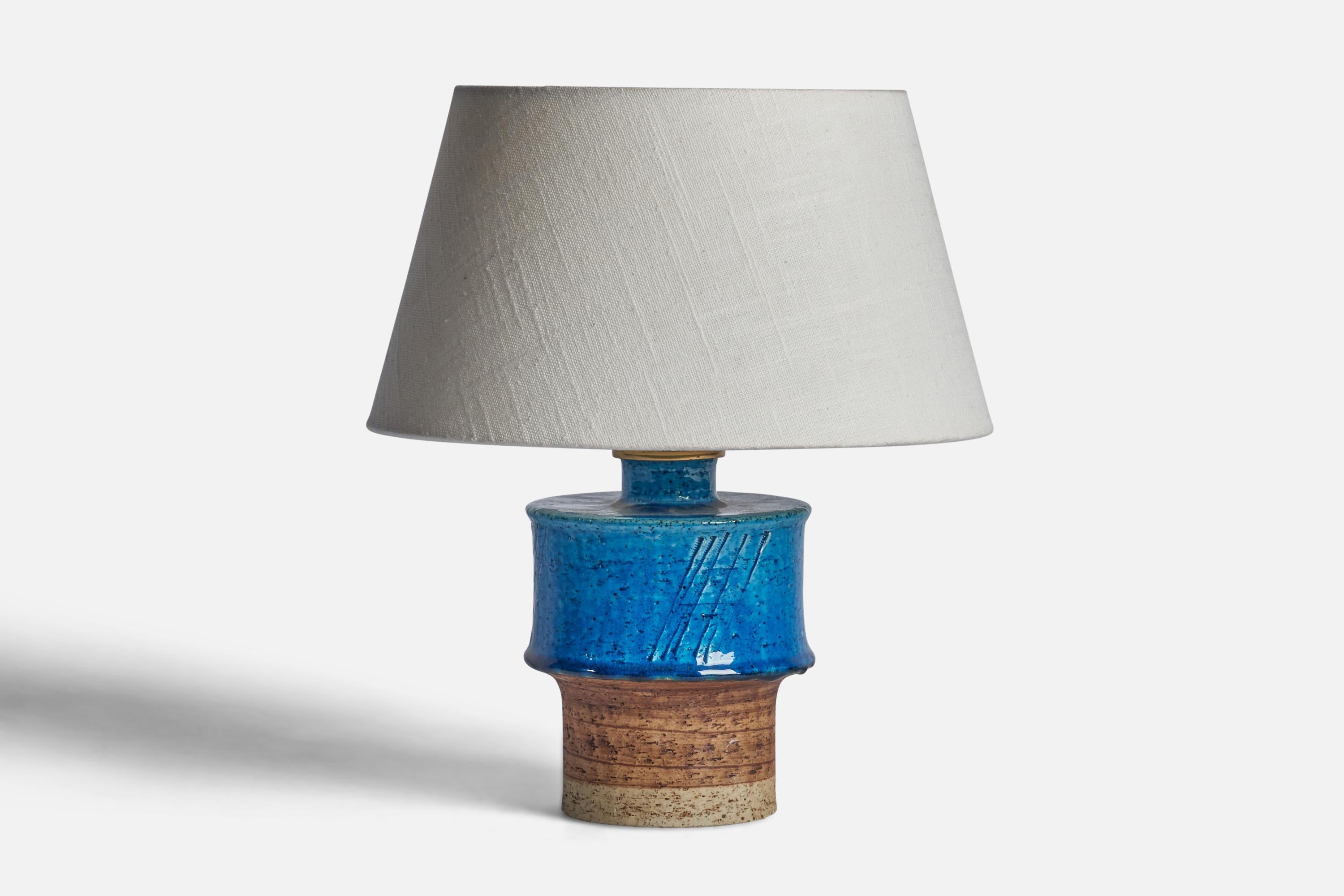 A brown and blue-glazed stoneware table lamp designed by Inger Persson and produced by Rörstrand, Sweden, 1960s.

Dimensions of Lamp (inches): 8.25” H x 4.5” Diameter
Dimensions of Shade (inches): 7” Top Diameter x 10” Bottom Diameter x