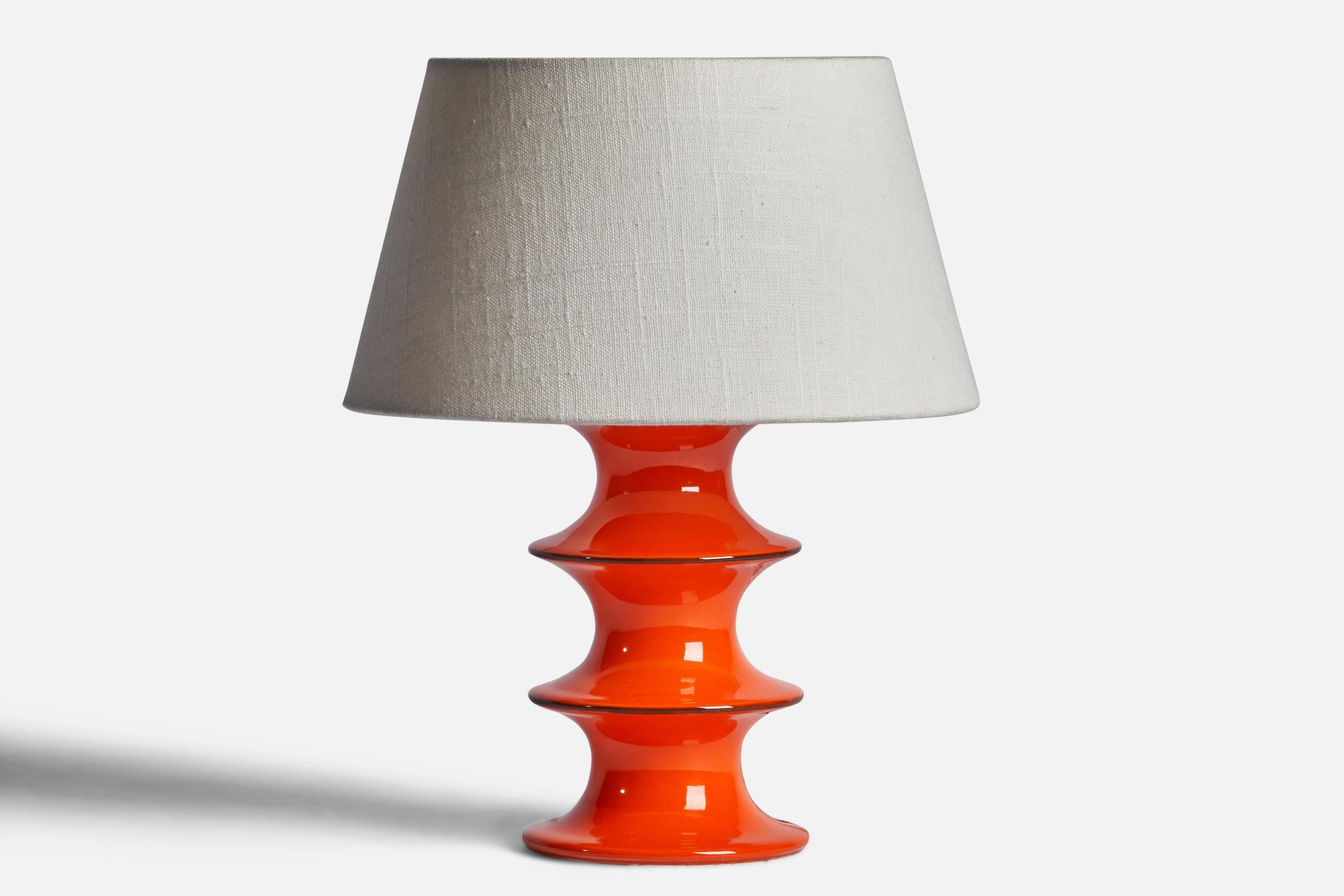 An orange-glazed stoneware table lamp designed by Inger Persson and produced by Rörstrand, Sweden, 1950s.

Dimensions of Lamp (inches): 9.35” H x 4.5” Diameter
Dimensions of Shade (inches): 7” Top Diameter x 10” Bottom Diameter x 5.5” H 
Dimensions
