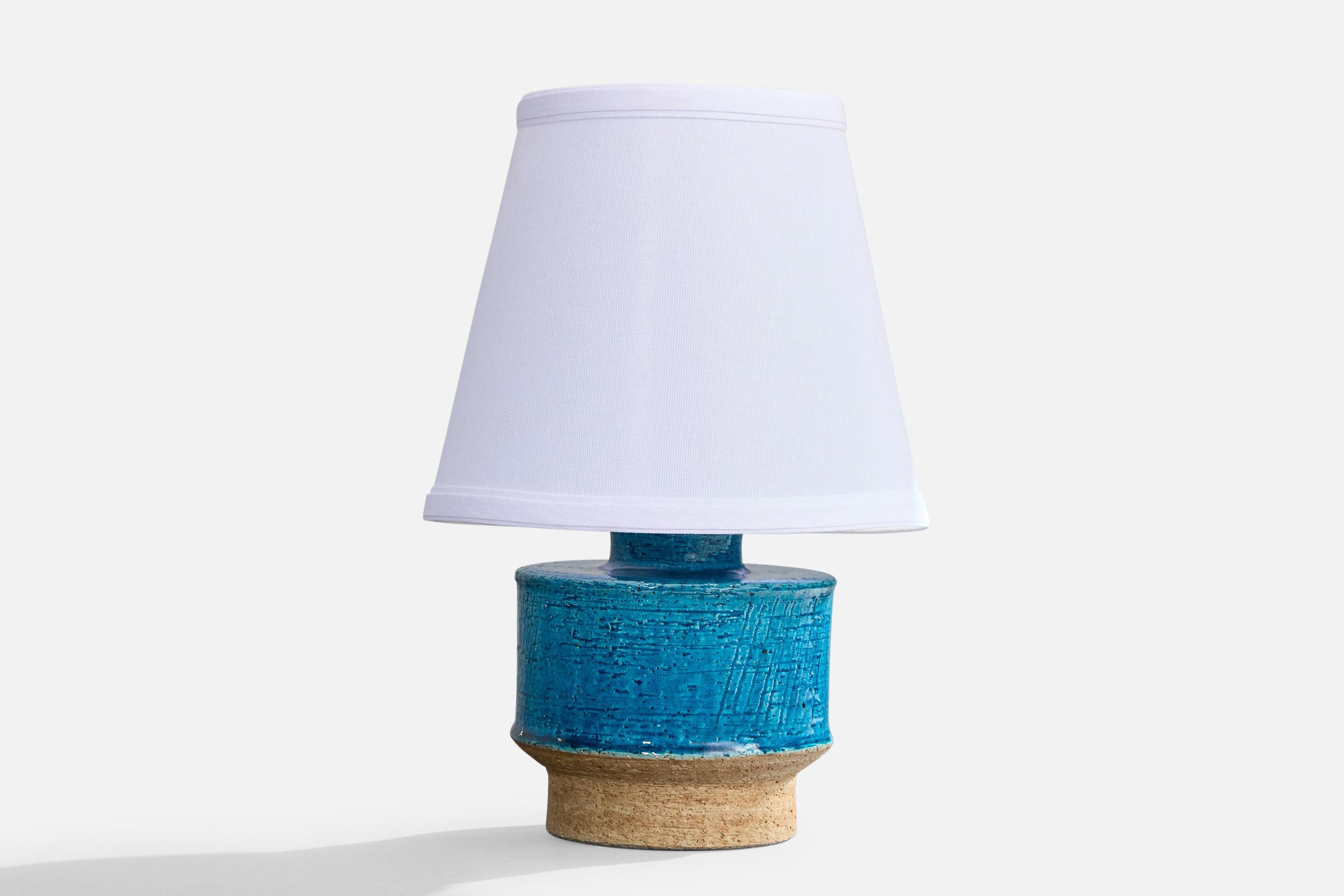 A blue and beige-glazed stoneware table lamp designed and produced in Sweden, c. 1960s.

Dimensions of Lamp (inches): 7.625” H x 5.0625” Diameter

Dimensions of Shade (inches): 5” Top Diameter x 8” Bottom Diameter x 7” H

Dimensions of Lamp with