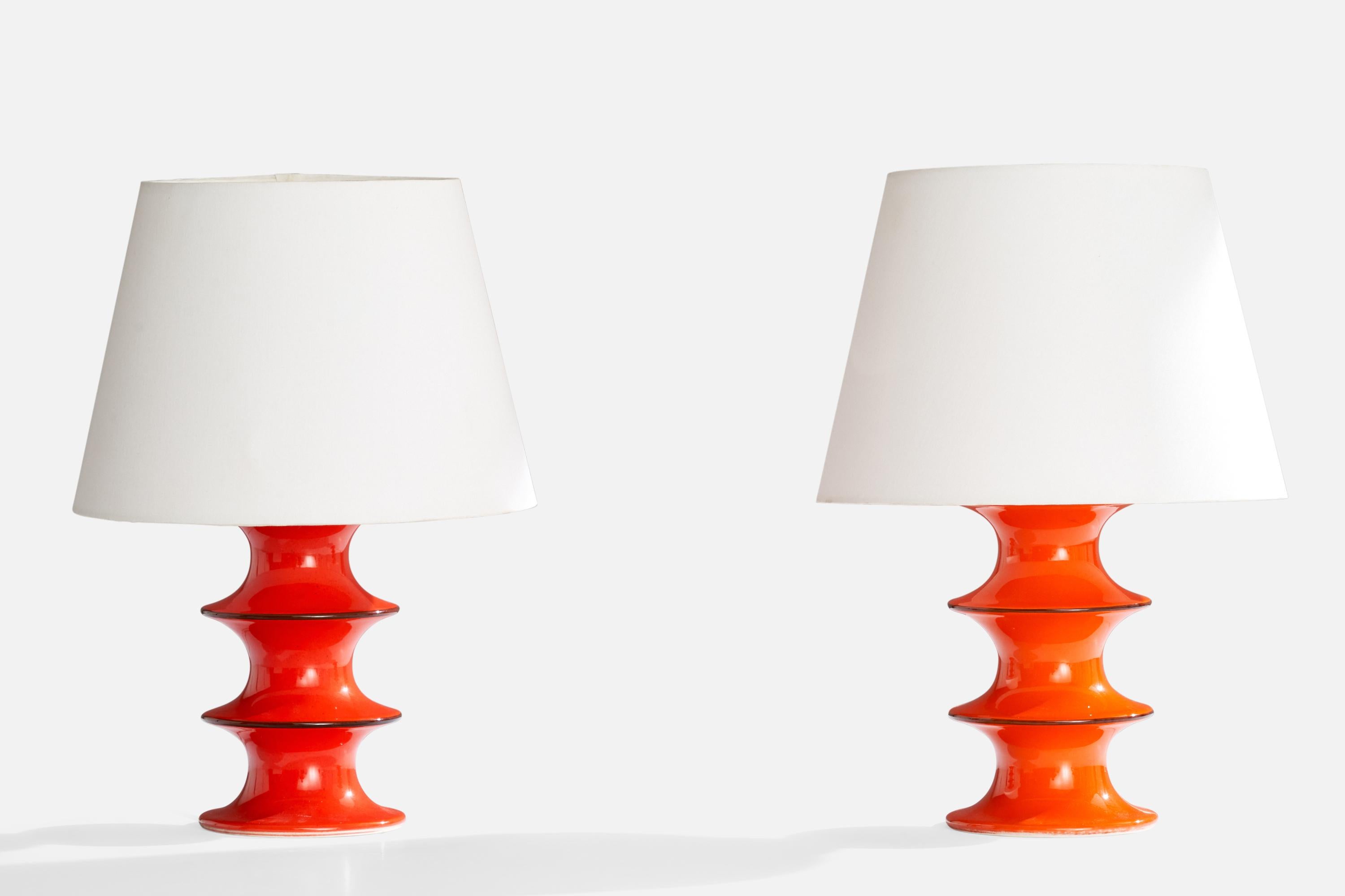 A pair of orange-glazed stoneware table lamps designed by Inger Persson and produced by Rörstrand, Sweden, 1960s.

Dimensions of Lamp (inches):  9.5“ H x  4.75” W x  4.75“ D

Dimensions of Shade (inches):  6.75“ Top Diameter x  10“ Bottom Diameter