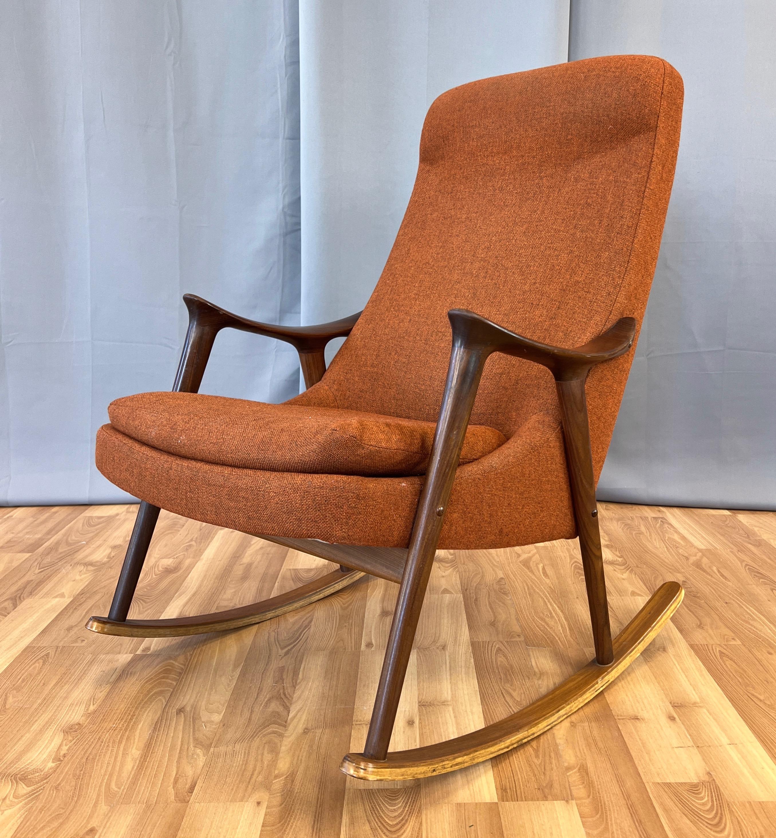 A 1960s Scandinavian Modern high-back teak rocking chair with original upholstery by Ingmar Relling for Westnofa of Norway.

Sculptural hand-crafted solid teak frame with a stained finish that resembles a cross between walnut and rosewood. On teak