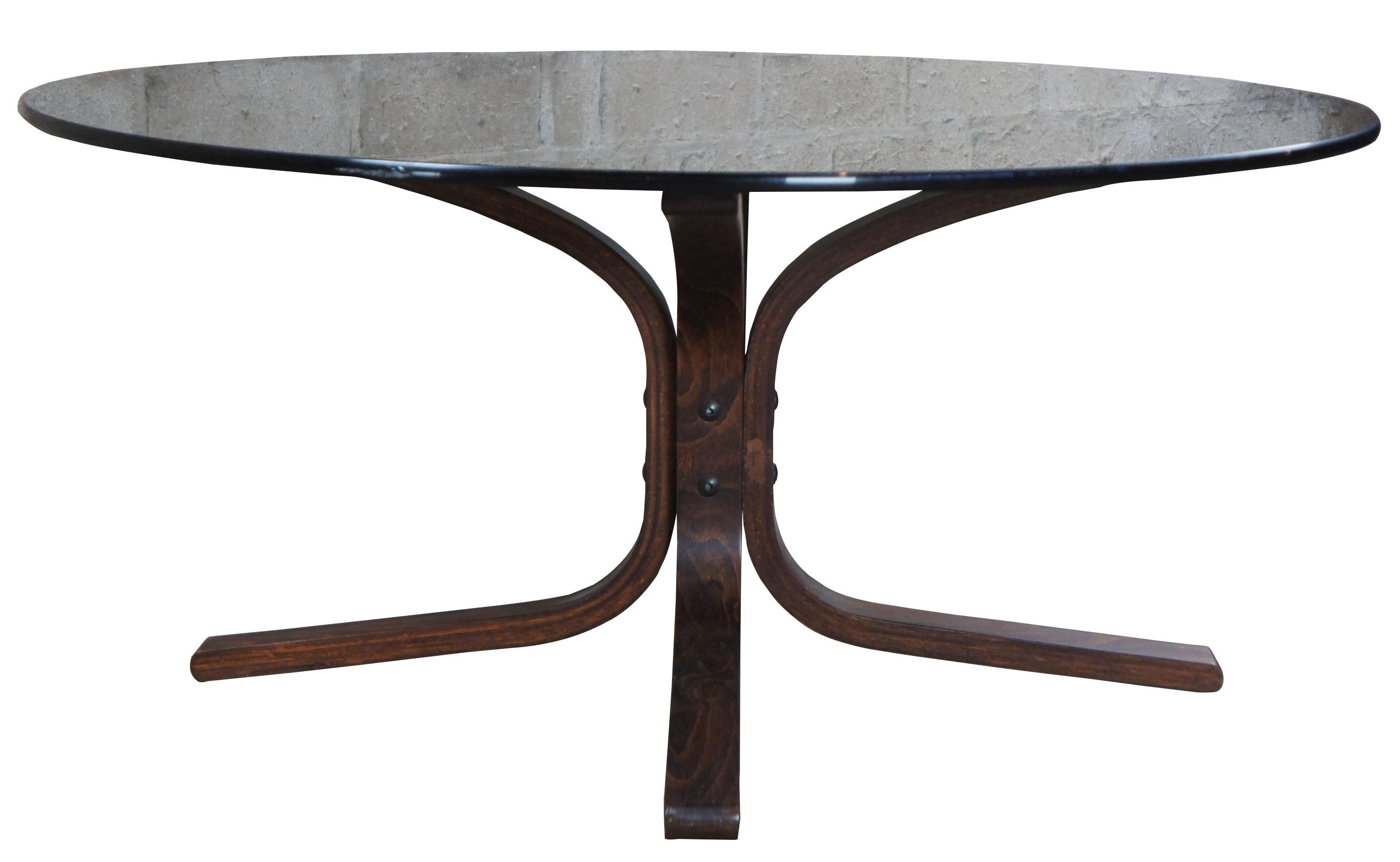 Ingmar Relling for Westnofa Siesta coffee table, circa 1960s. Features a smoked glass top over a teak bentwood base.
   