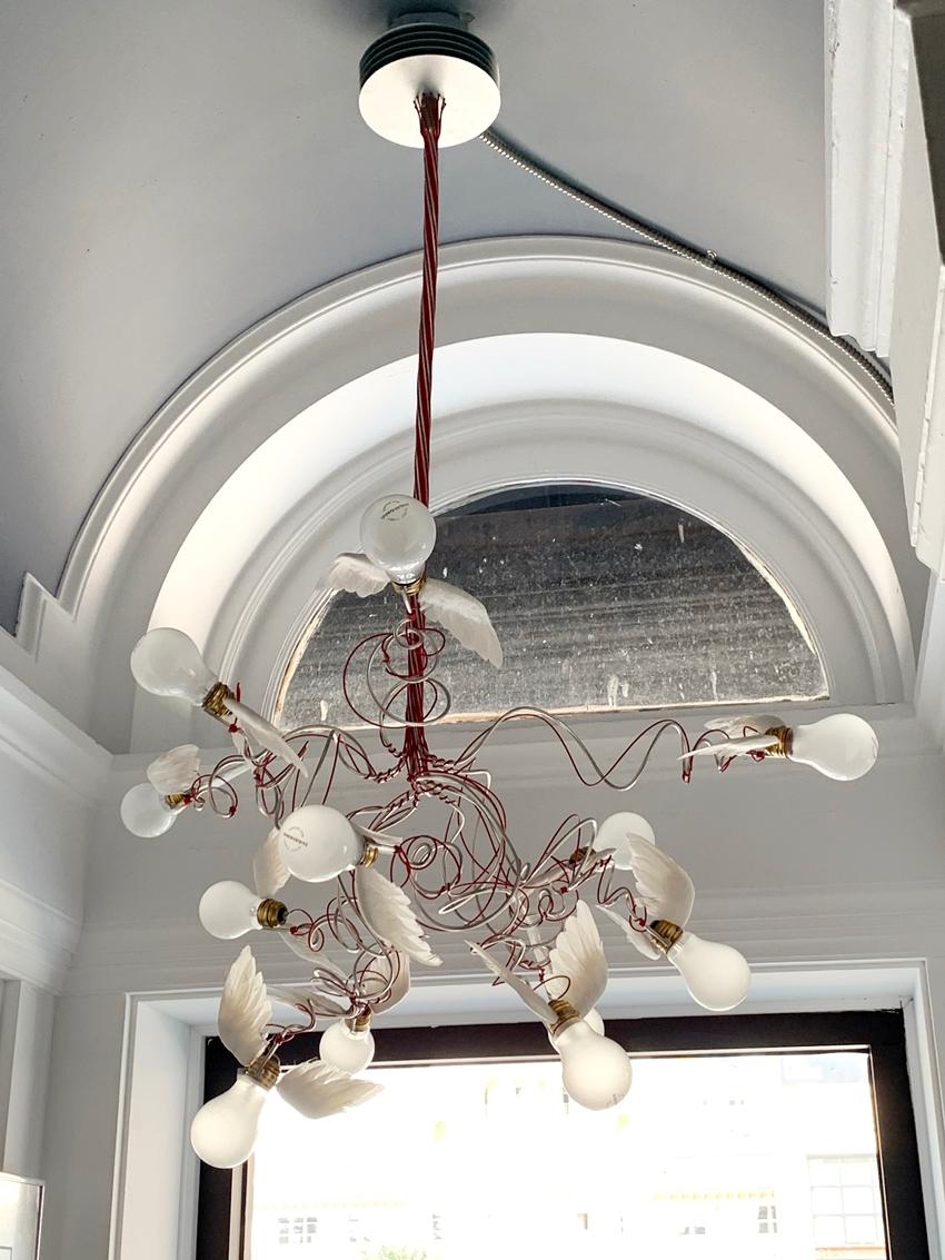 Birdie chandelier features red curly branch-like electrical wires and 12-pcs of low-voltage lighting bulbs, each equipped with goose-feather wings. This large contemporary chandelier adds a playful yet distinctive touch for the living room area or