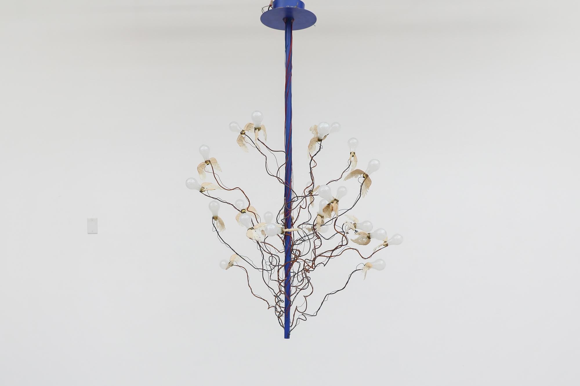 Ingo Maurer 'Birds Birds Birds' Chandelier with real goose feather wings on individually adjustable electrical cable arms and blue enameled metal frame. An artistic take on the relationship between the animal world using modest materials. in very