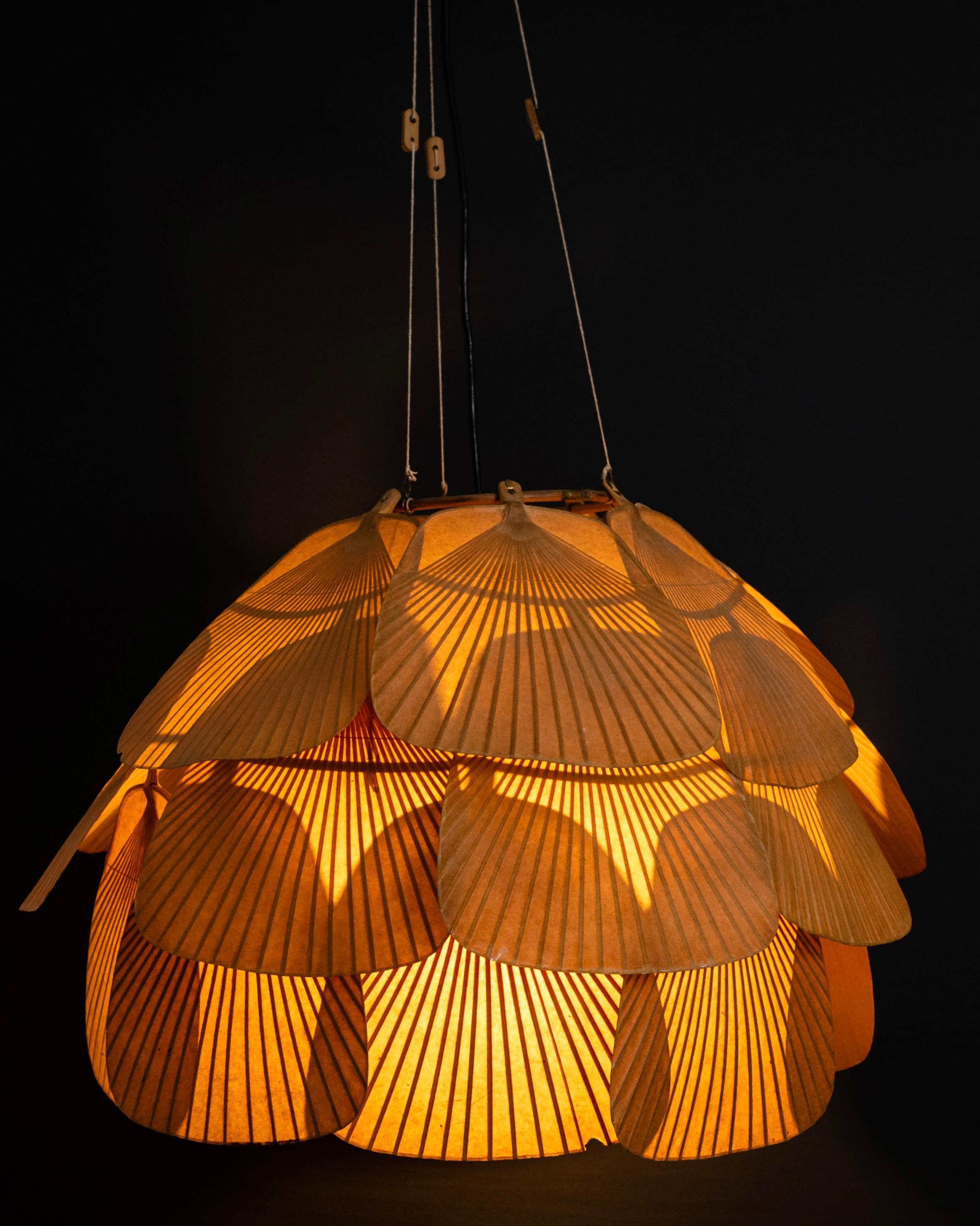 Splendid version of the rare Uchiwa Fan lamp by Ingo Maurer. We have seen many Ingo Maurer lamps but this one is stunning. It has such an amazing patina due to its age, only reachable by keeping this in a dark spot all those years, without any