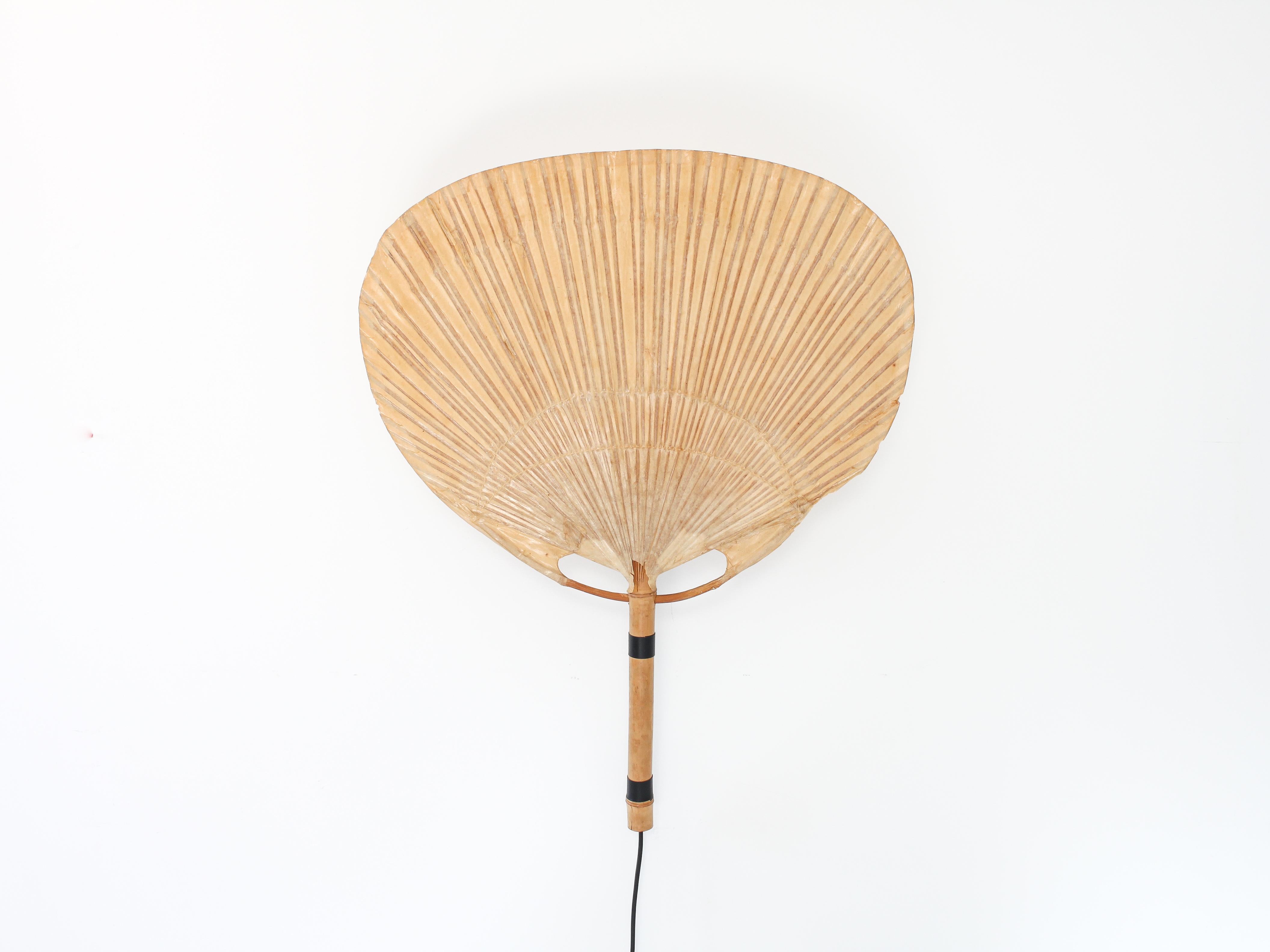 An “Uchiwa” wall light by Ingo Maurer for M design, Germany, 1970s. 

Uchiwa lamps, uchiwa being the Japanese for fan, were handmade from bamboo, wicker and Japanese rice paper. Maurer travelled to Japan to develop his uchiwa range where he found