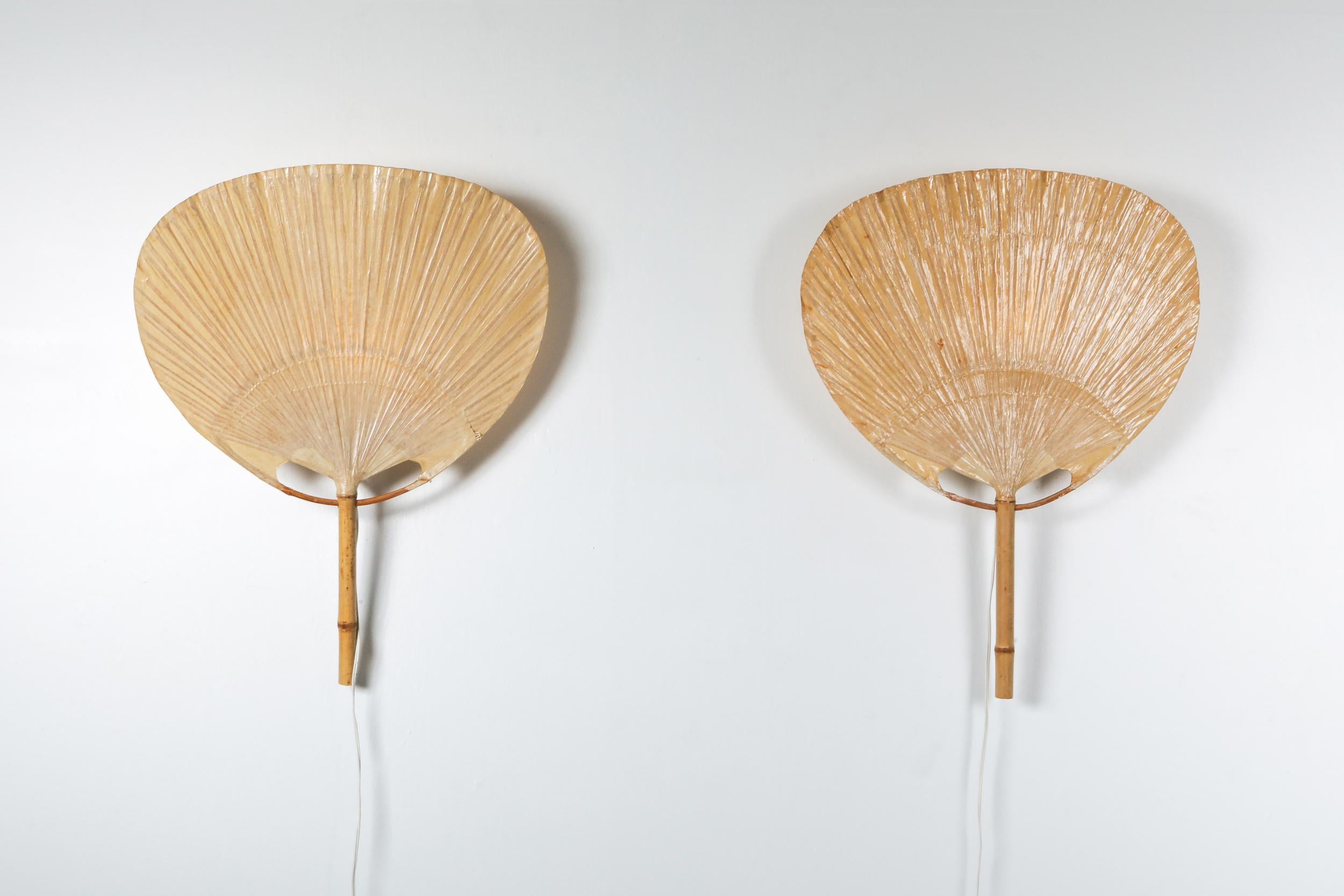 Uchiwa sconces by Ingo Maurer.

The lamps were handmade of bamboo and Japanese rice paper in 1977.
Ingo Maurer’s interest in paper for lampshades was linked with his interest in Japan. He produced various lamps from traditional Japanese fans
