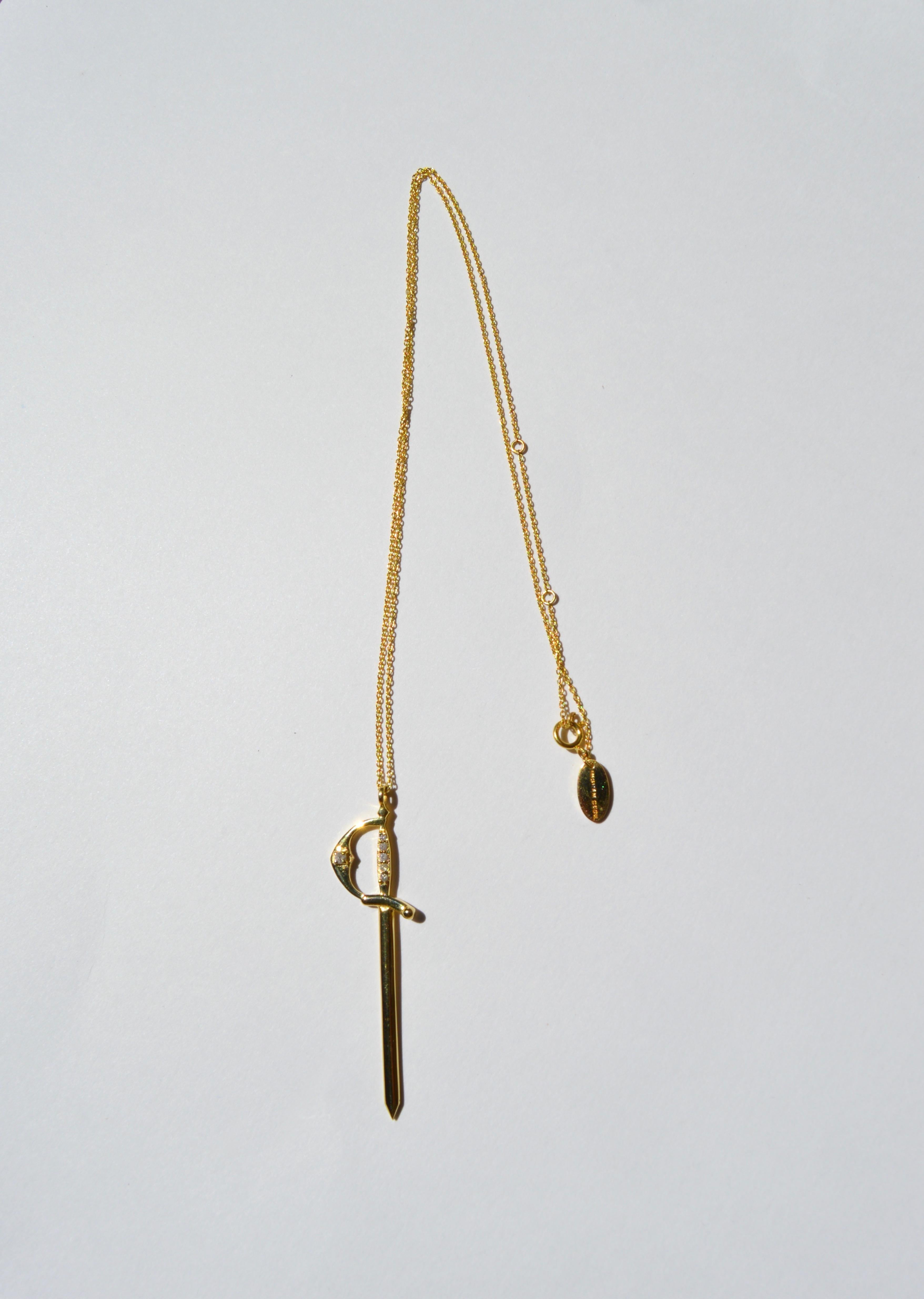 Solid 14K yellow gold and diamond sword pendant on an 18