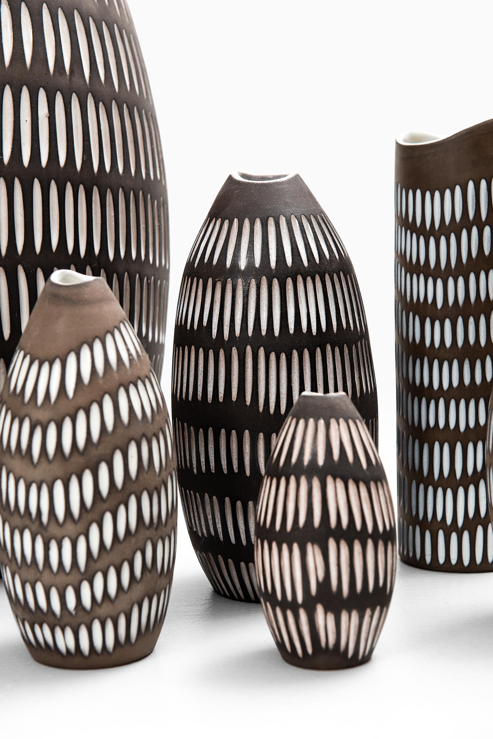 A set of 8 ceramic vases model Negro designed by Ingrid Atterberg. Produced by Upsala Ekeby in Sweden.