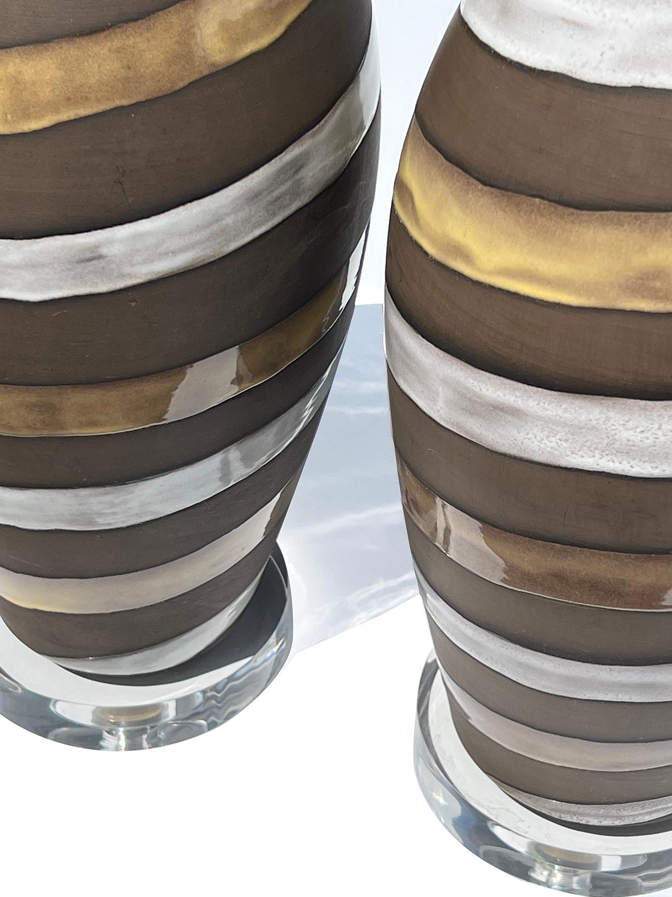 each large glazed ceramic baluster-form table lamp on later lucite bases designed by Swedish artist Ingrid Atterberg as part of the 