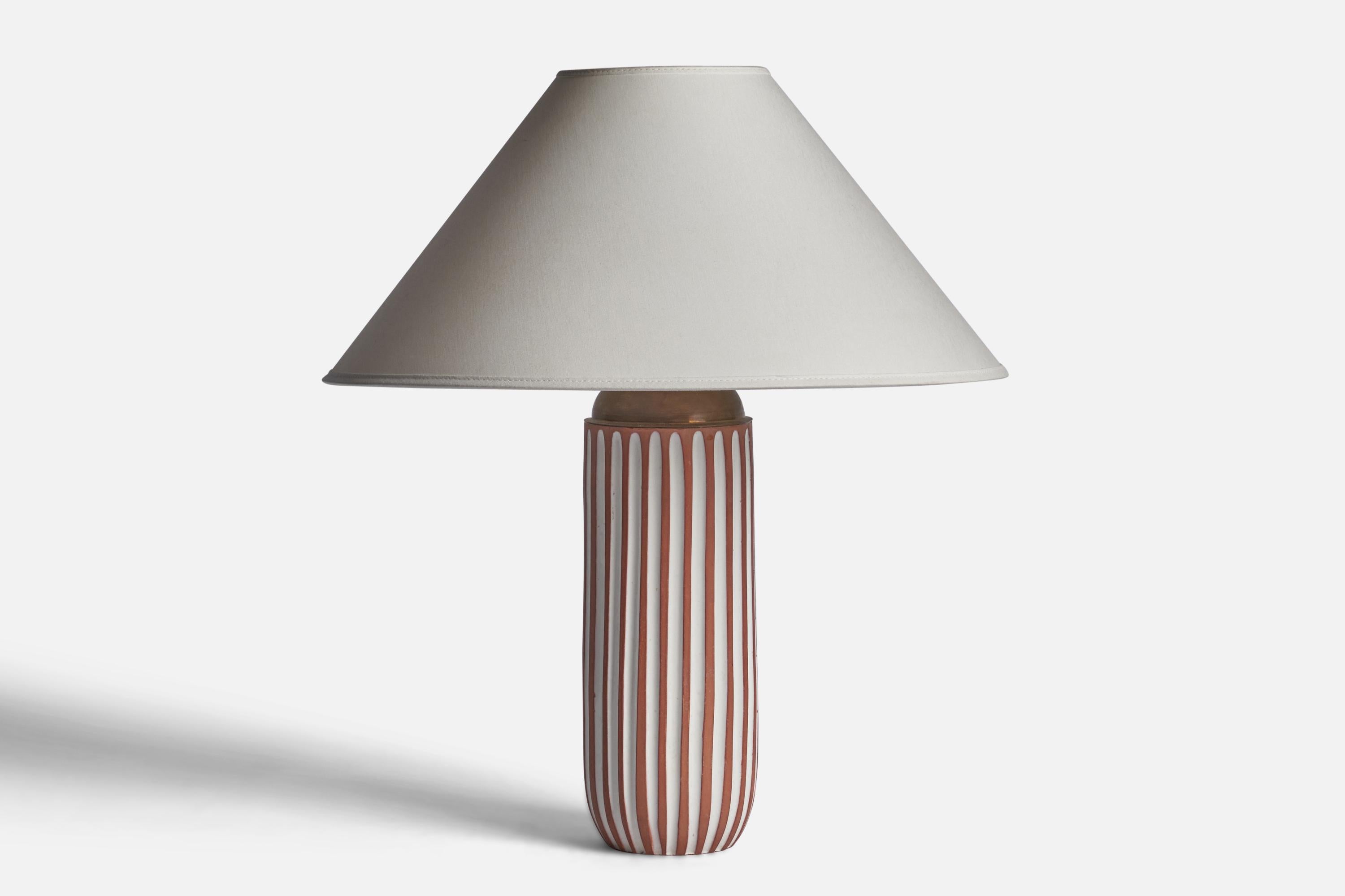 A fluted white and red earthenware table lamp designed by Ingrid Atterberg and produced by Upsala Ekeby, Sweden, 1950s.

Dimensions of Lamp (inches): 13.45” H x 4” Diameter
Dimensions of Shade (inches): 4.5” Top Diameter x 16” Bottom Diameter x