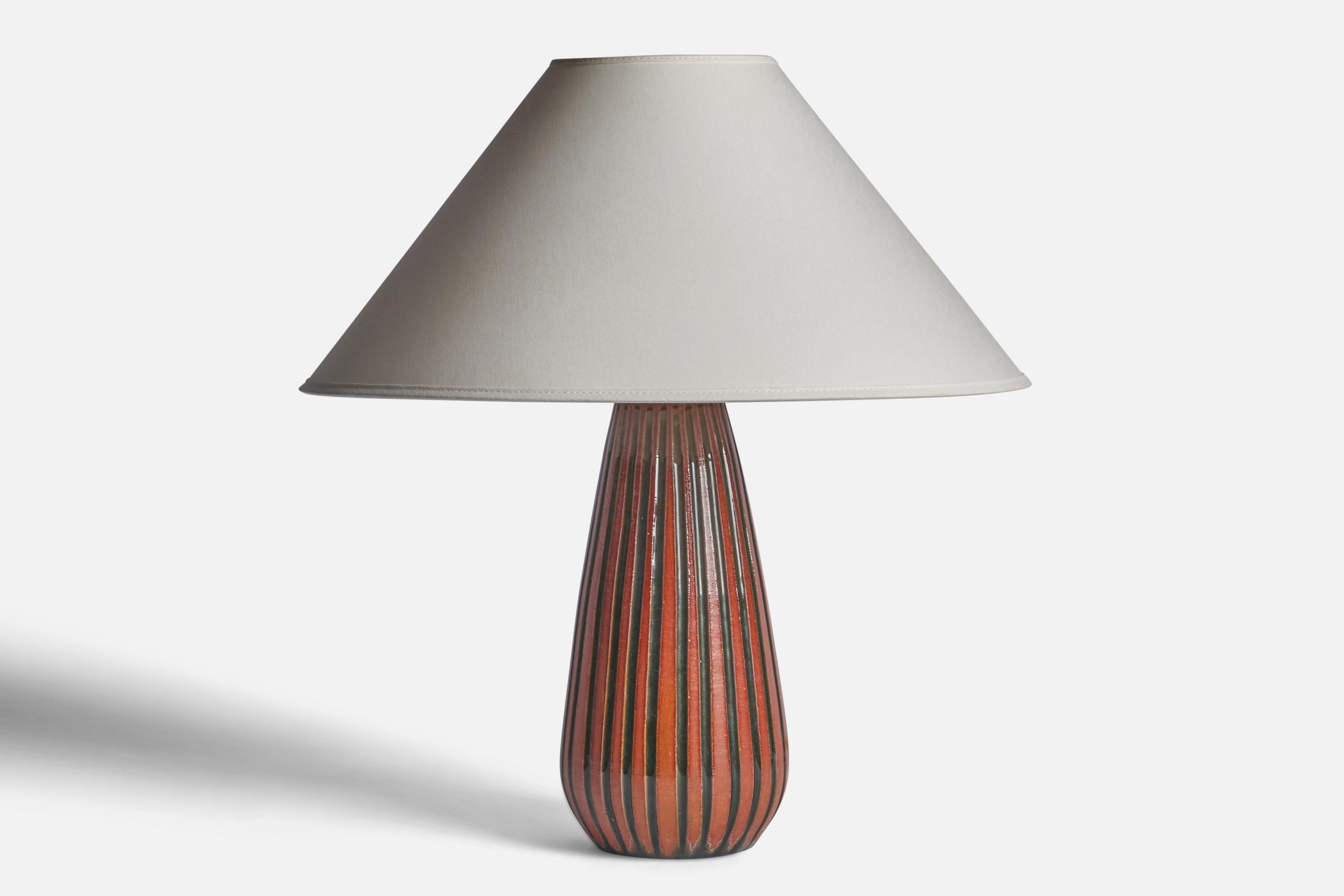 An orange and black-glazed earthenware table lamp designed by Ingrid Atterberg and produced by Upsala Ekeby, Sweden, 1950s.

Dimensions of Lamp (inches): 12.5” H x 5” Diameter
Dimensions of Shade (inches): 4.5” Top Diameter x 16” Bottom Diameter x