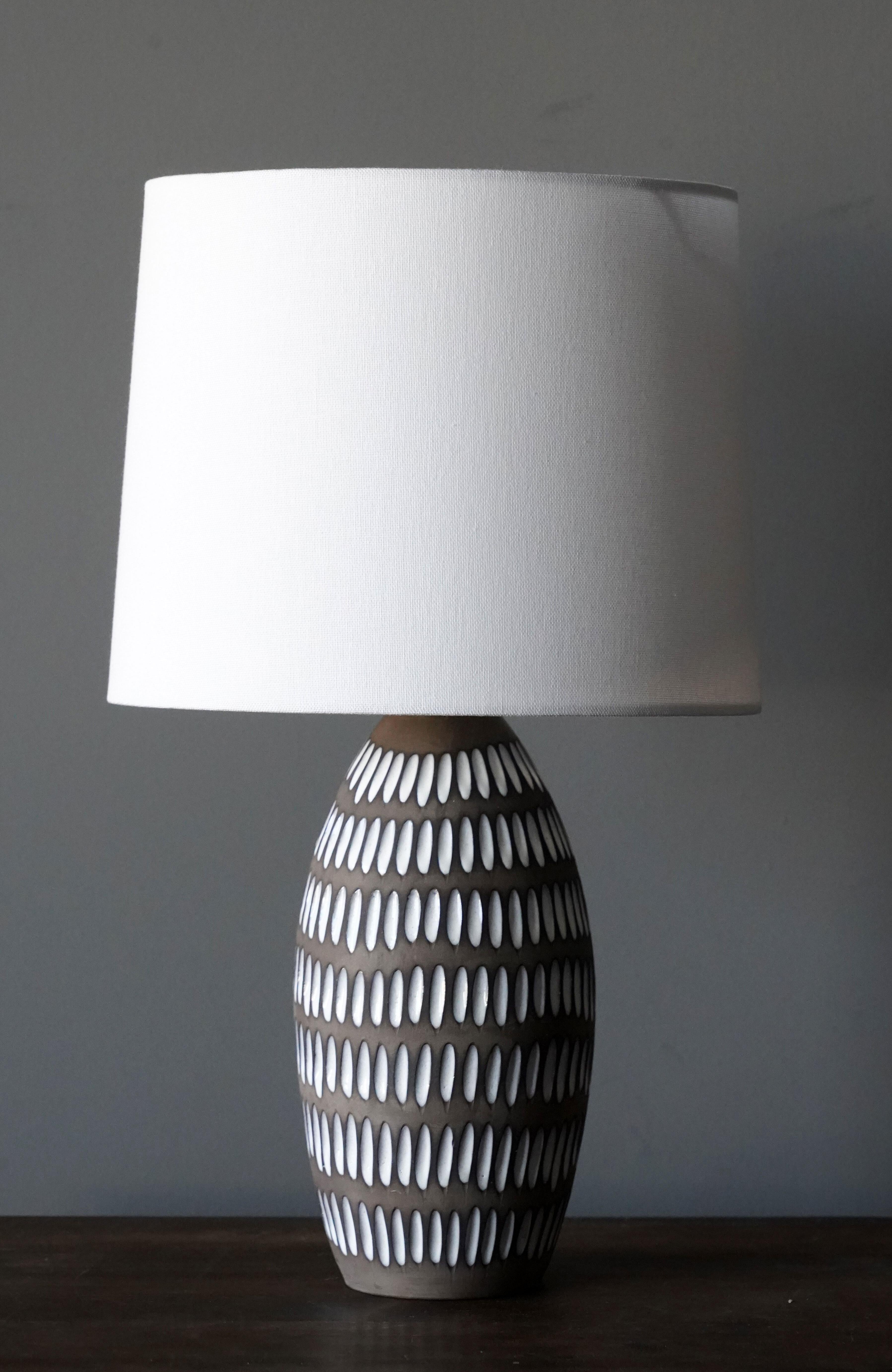 A table lamp designed by Ingrid Atterberg. Produced by Upsala Ekeby, Sweden, 1950s. Stamped.

Sold without lampshade. Stated measurements exclude lampshade.

Other designers of the period include Axel Salto, Paavo Tynell, Lisa Johansson-Pape,