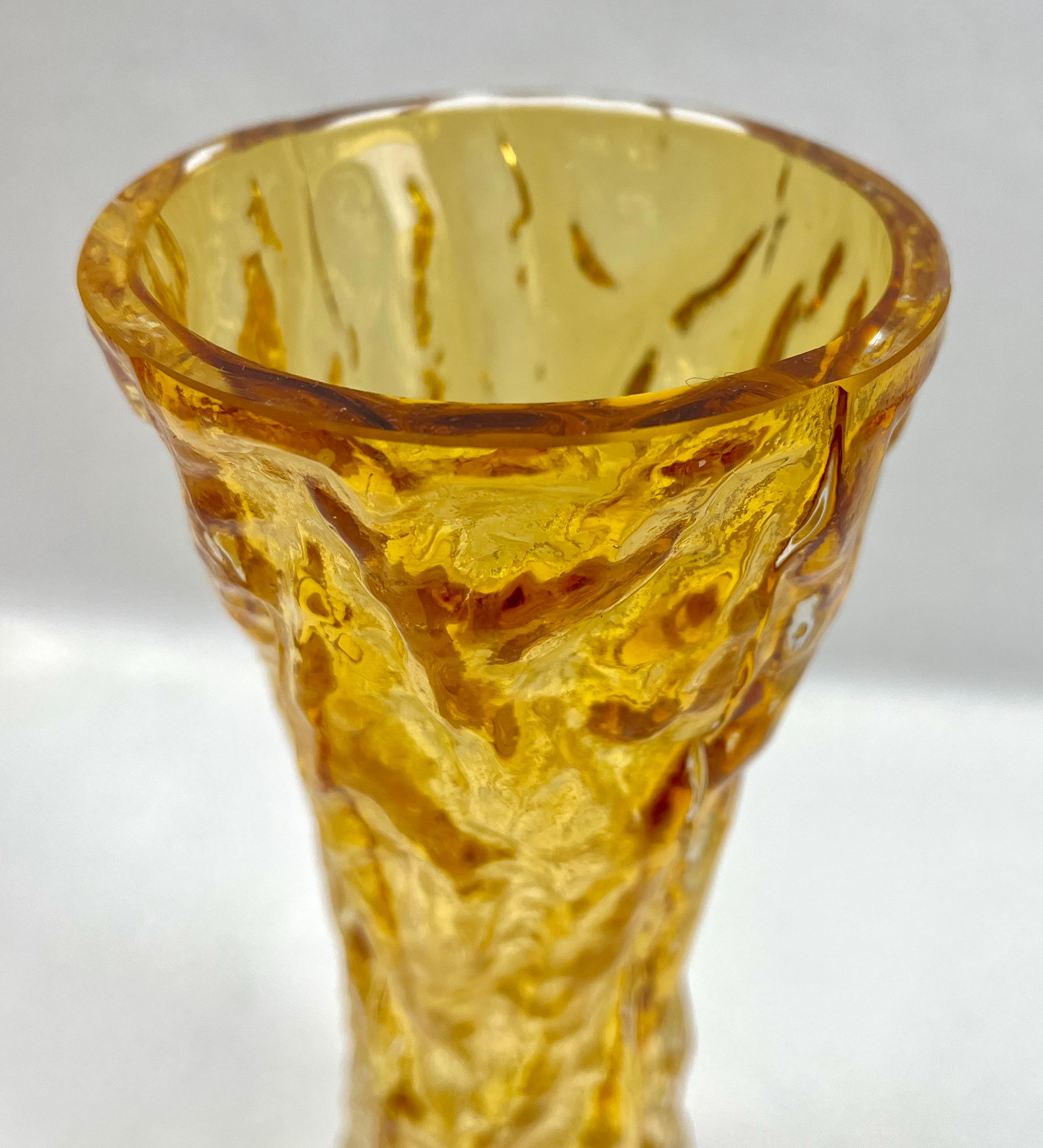Impressions made from tree bark were first used to make moulds in the early 1970s, as factories investigated new ways to bring surface texture to glass objects. Some models are colored throughout while others have a colored core with a thick