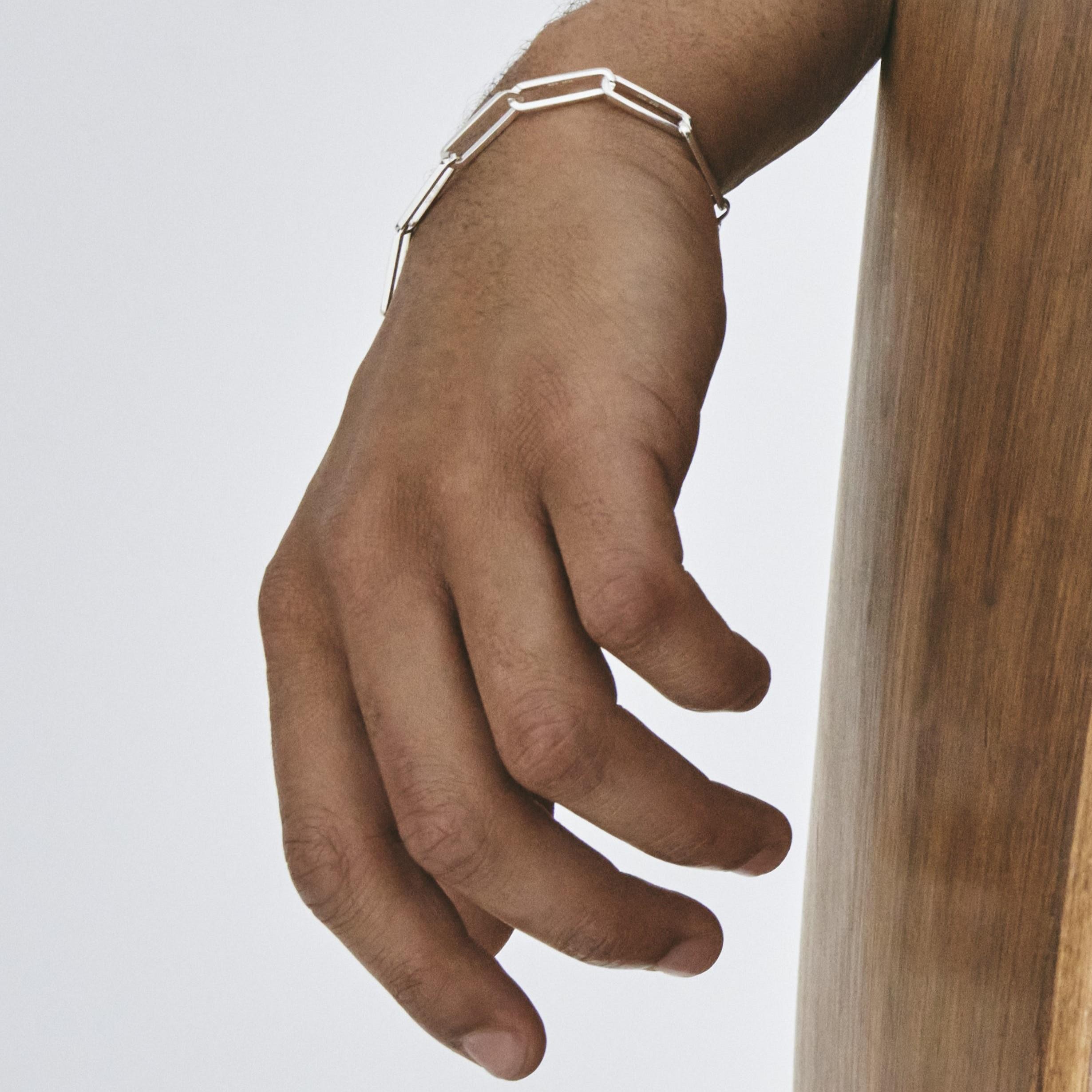 Also available in sterling silver with 1 gold link; 18k gold with 1 silver link, and in small size.

A superb bracelet of links in recycled sterling silver. Inspired by classic Scandinavian design and the ancient art of Japanese wood joinery, each