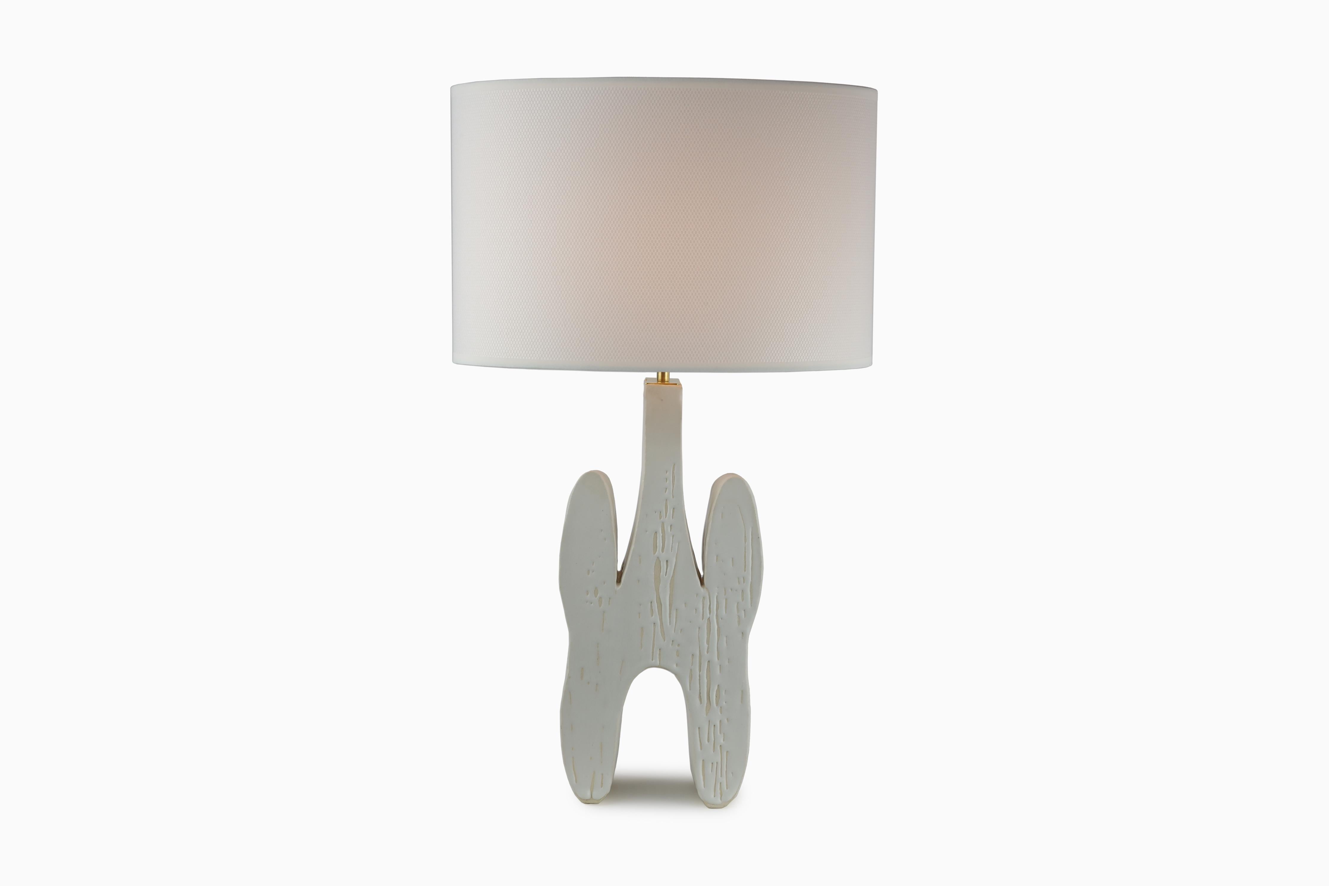 The Inkblot Table Lamp is designed from an actual inkblot, giving it a symmetrical shape. The body of the lamp is hand sculpted clay. Each lamps glaze will vary and be unique because of the organic process. The Inkblot Table Lamp would be a great