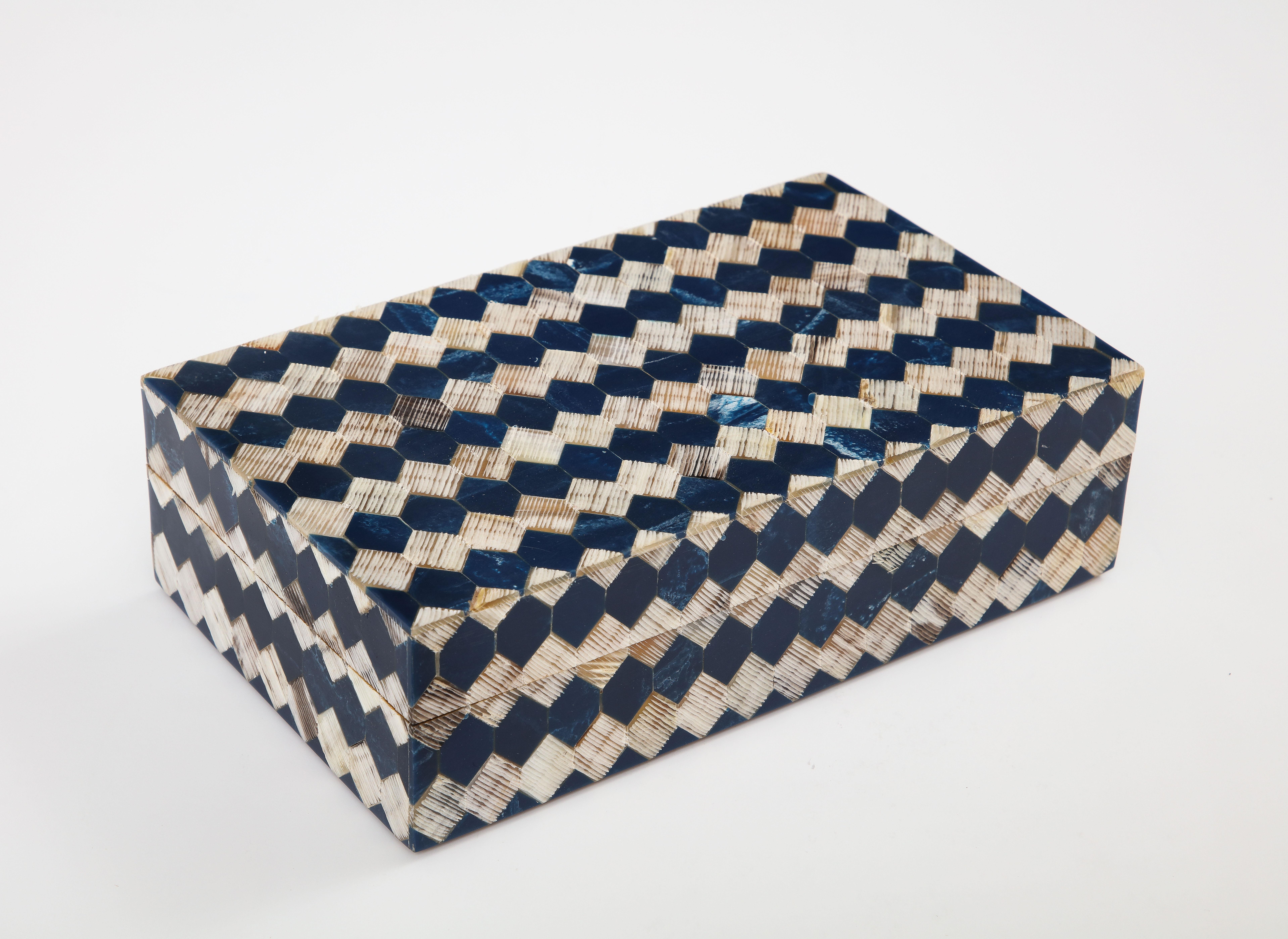 Decorative keepsake/jewelry box clad in hand incised natural horn and ink blue dyed bone tiles hand set on a wood structure. A great addition to any desk or coffee table.