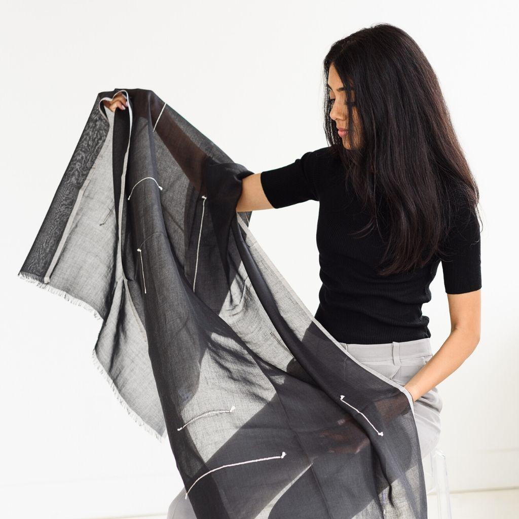 Custom design by Studio Variously, Ink Mist is a light weight scarf. It is beautifully handwoven and hand knotted in cotton by master artisans in Nepal.  

A sustainable design brand based out of Michigan, Studio Variously exclusively collaborates
