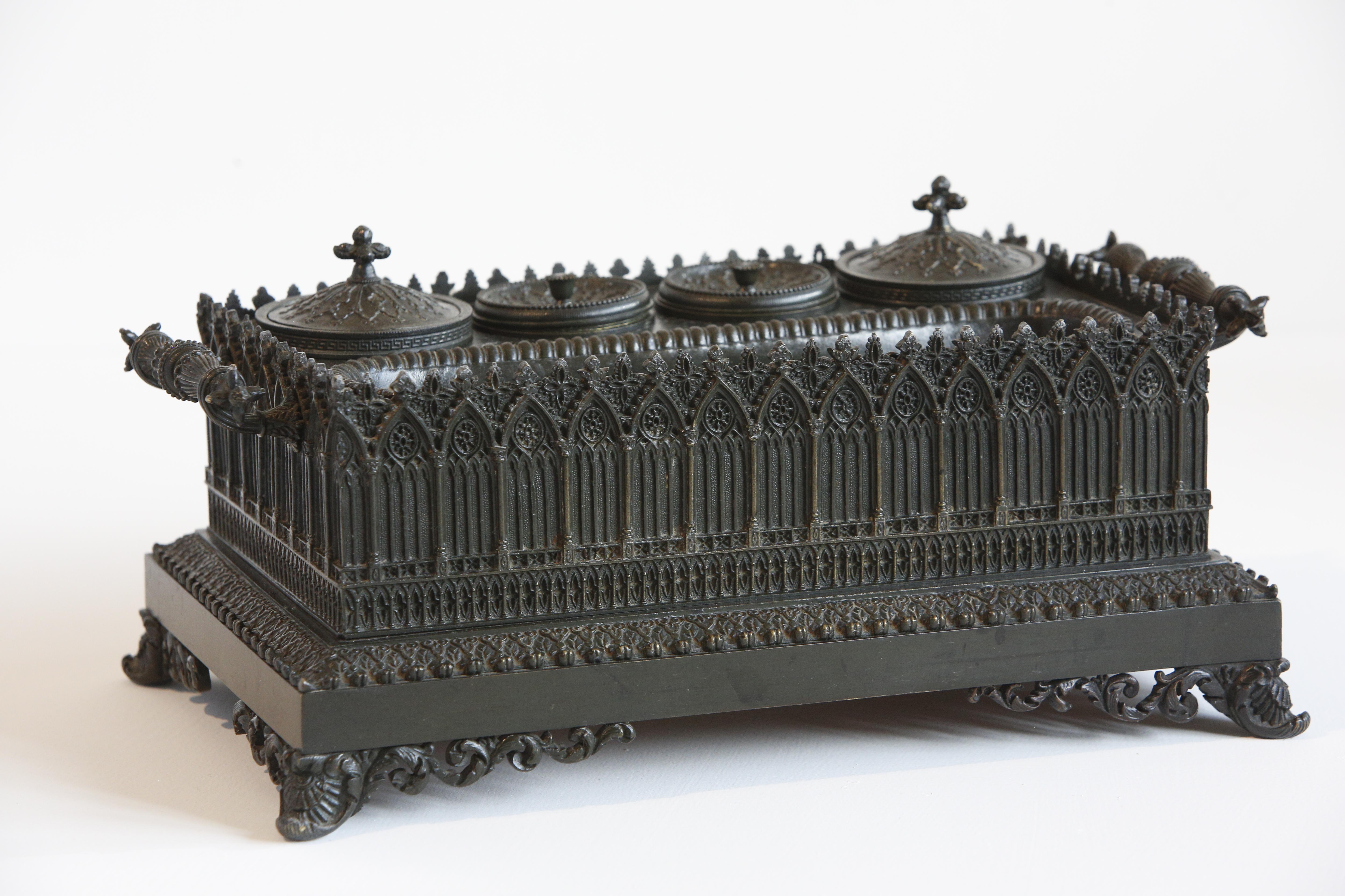 Inkwell Charles X French Gothic in Patinated Bronze, Early 19th Century 

Gothic inkwell in patinated bronze and fine chiseled bronze decorated with arcatures, rosettes, polylobed motifs and cut and openwork festoons. It has four cups and four pen