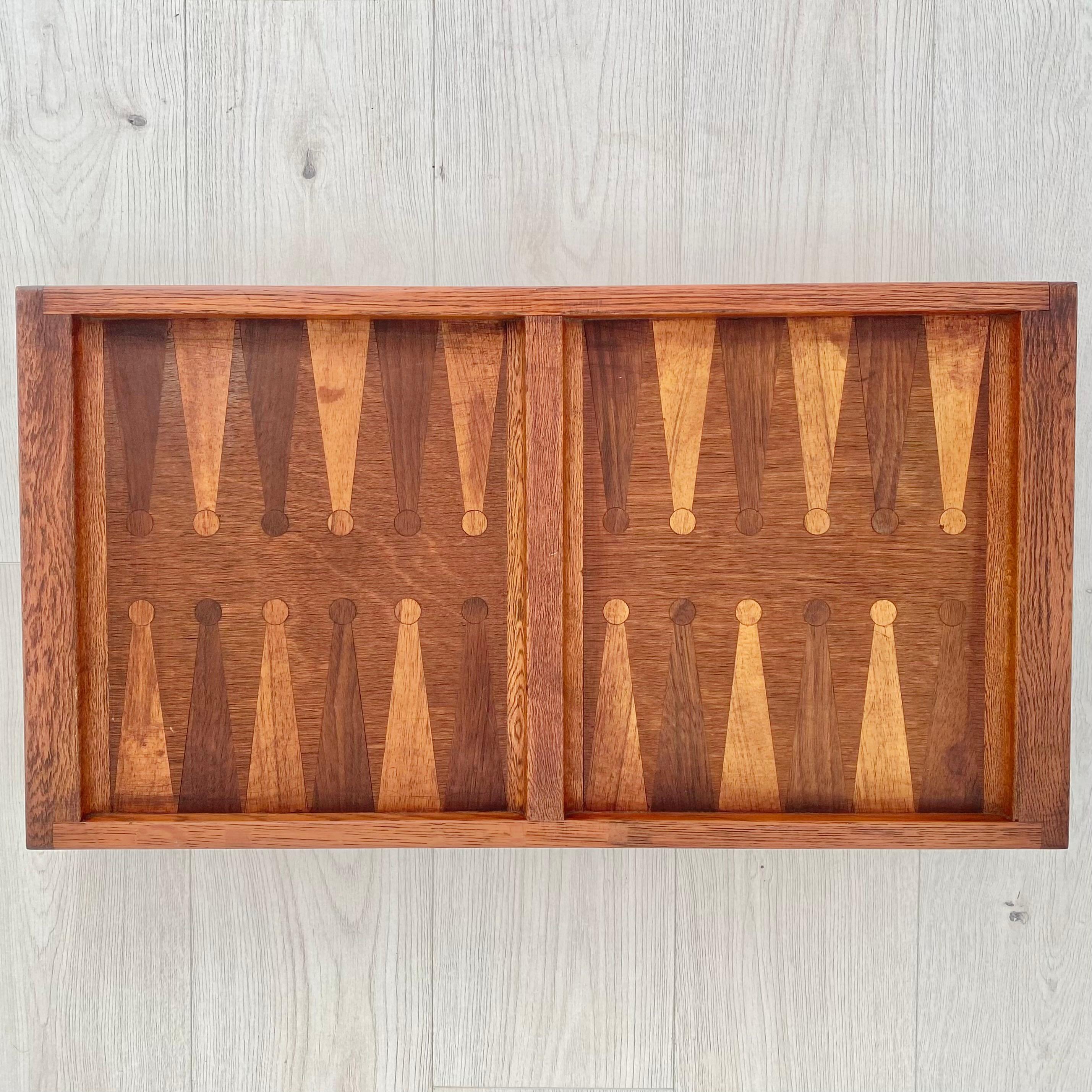 Unique backgammon board made in Denmark, circa 1960s. Inlaid table with intricate design details. Footed bottom so the board floats 3.5