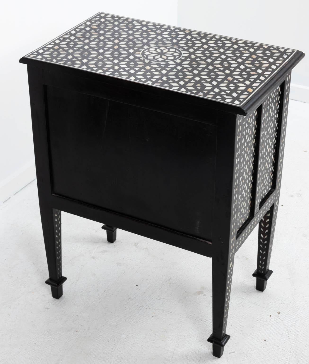 Inlaid bedside tables that each feature a single drawer and two door cabinet. The pieces are also detailed with geometric inlay throughout. Please note of wear consistent with age including finish loss. Priced each.