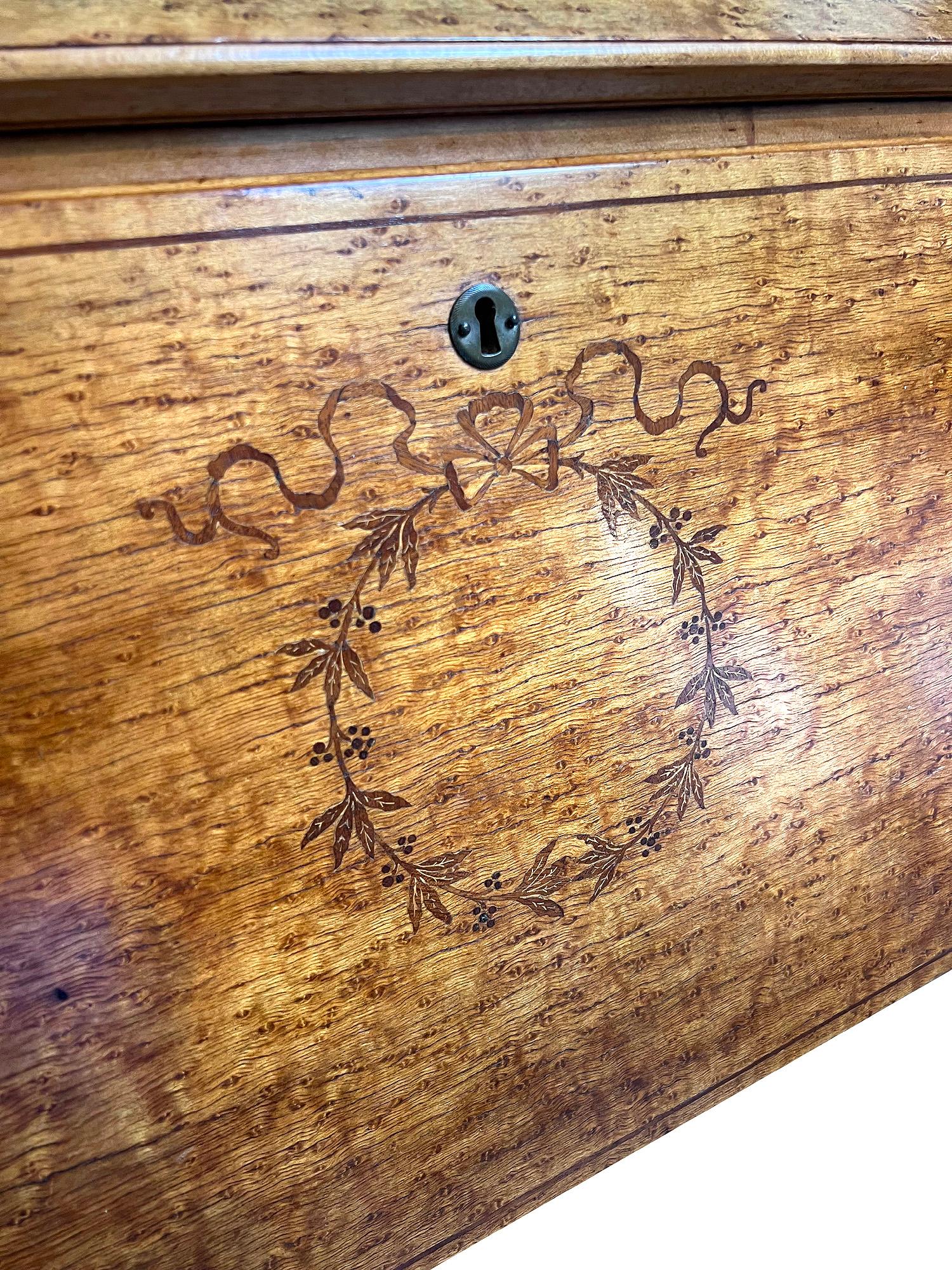 This is a spectacular type two Birdseye Maple Desk with the most beautiful detailed inlay. The most endearing part of this desk are the legs, shaped by a master furniture maker they are perfect. A functional desk that is as beautiful as it is