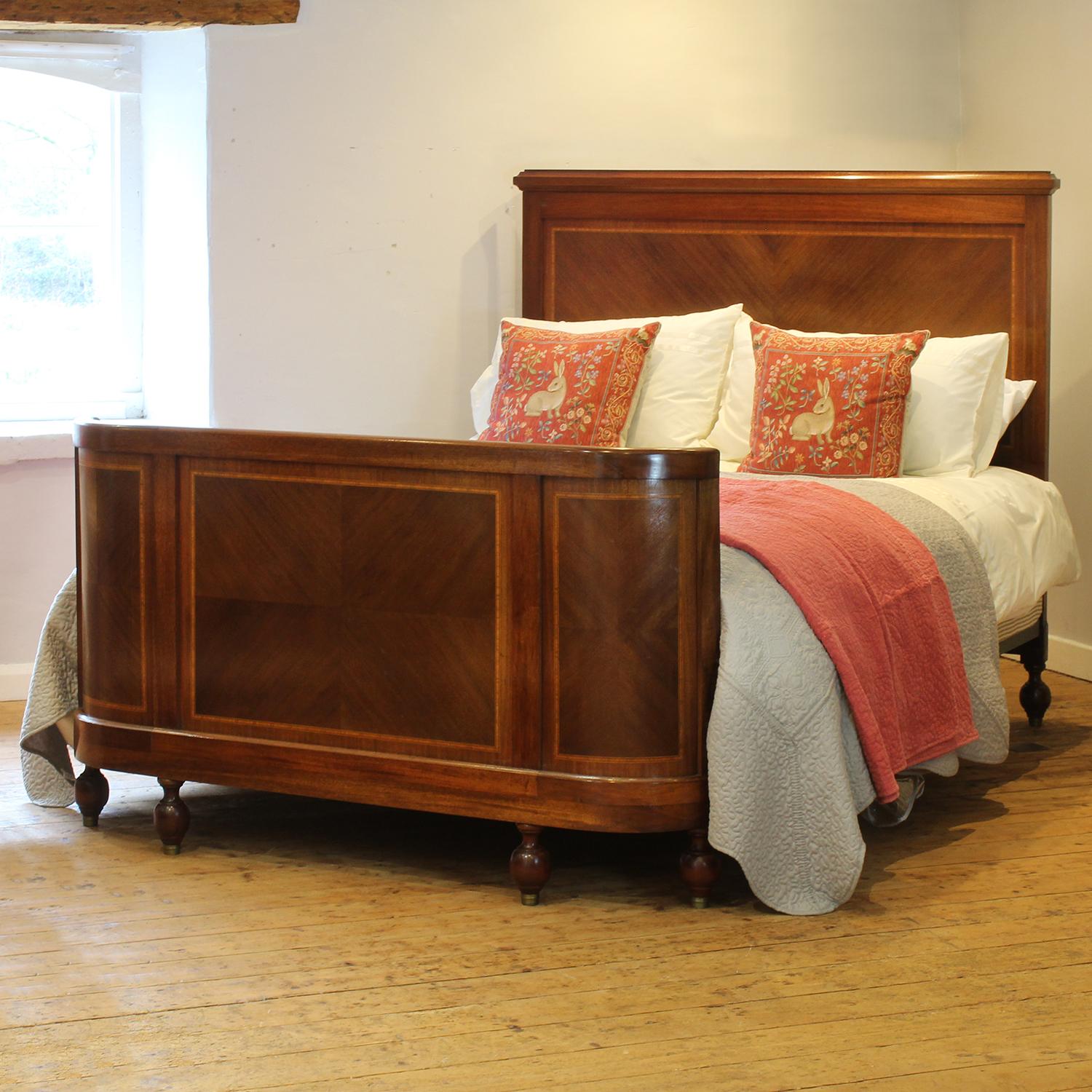 A superb example of an inlaid antique bed in mahogany with fine string inlay work, quartered veneered panels and bow foot end. 

This bed accepts a US Queen Size (or UK King Size), 5ft wide (60 in), base and mattress set.

The price includes a firm