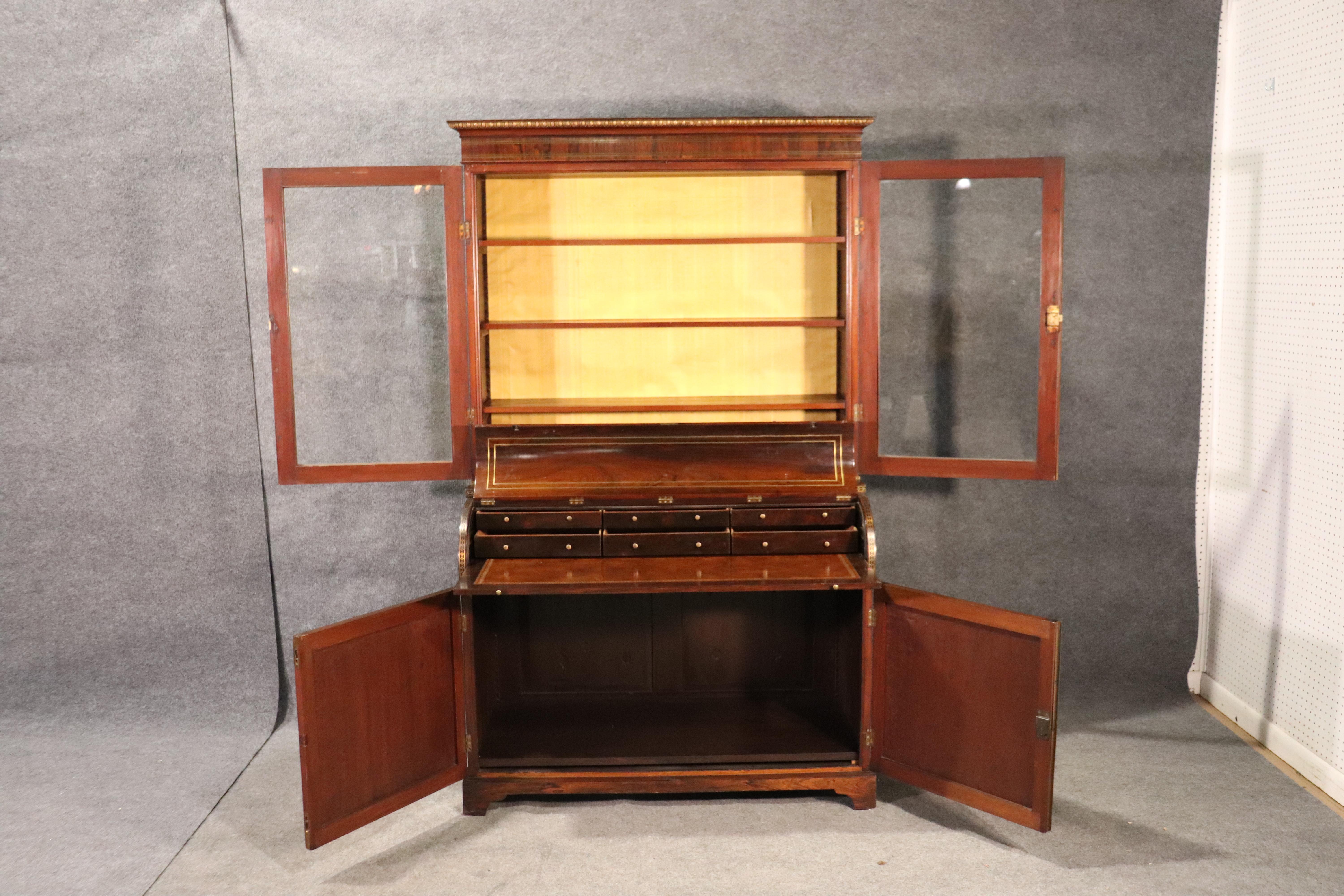 This is a fantastic and very clean 1840s era English Regency desk. Made of rosewood with brass inlay in the style of Andre Boulle, this desk is a handsome addition to you office or livinroom area. The desk features a leather writing surface and is