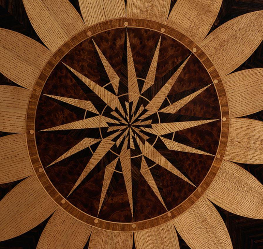 A circular geometrically inlaid tilt top breakfast table, on a four splay base with gun barrel column terminating in brass castors. 

Please note we are currently working to a 30-36 week lead time and that this item is made to order. 