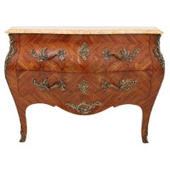 Inlaid chest of drawers with a marble top in the Louis XV style, France.