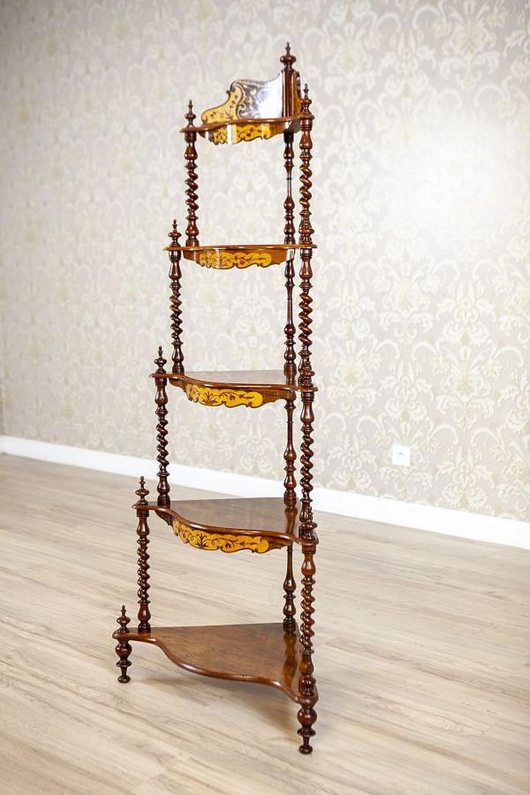 Inlaid Corner Étagère from the late 19th century

We present you this beautiful, inlaid étagère of a lightweight form. The piece is composed of five shelves supported on turned small columns. Each shelf (except for the most bottom one) is