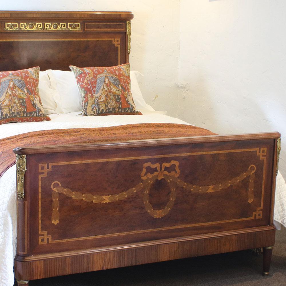A fine mahogany bed from the early 20th century with ormolu decoration and inlay work depicting garlands and ribbons.

This bed accepts a British King Size or American Queen Size base and mattress set (5ft wide, 60in or 150cm)

The price is for