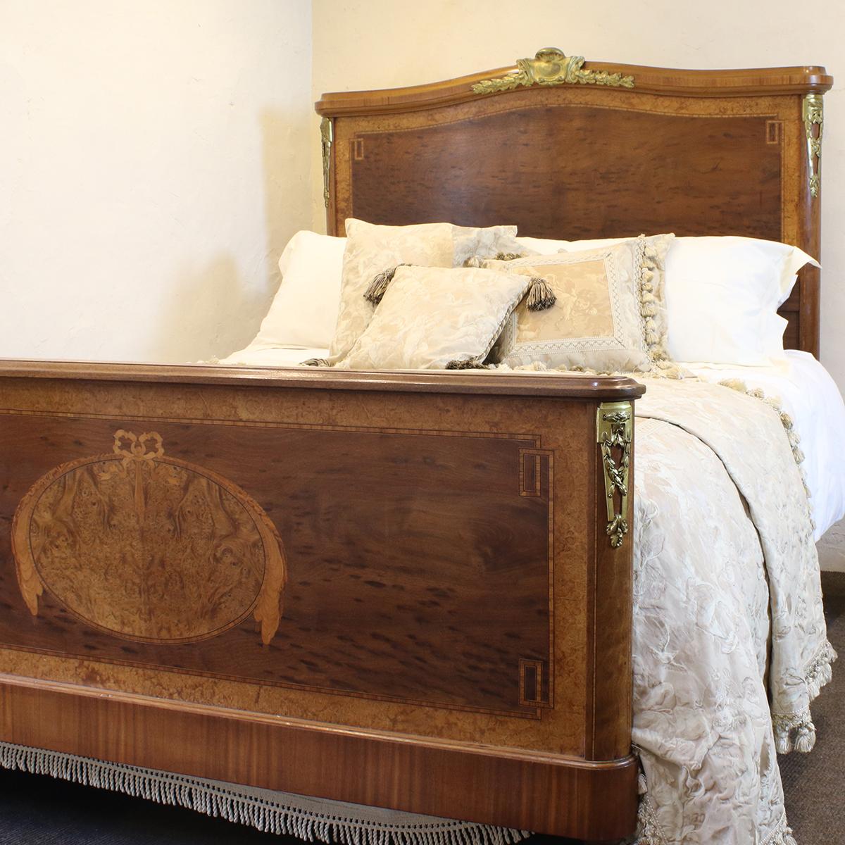 A fine mahogany bed from the early 20th century with burr walnut veneer and inlay work.

This bed accepts a British King Size or American Queen Size base and mattress set (5ft wide, 60in or 150cm)

The price is for the bed frame alone. The base,