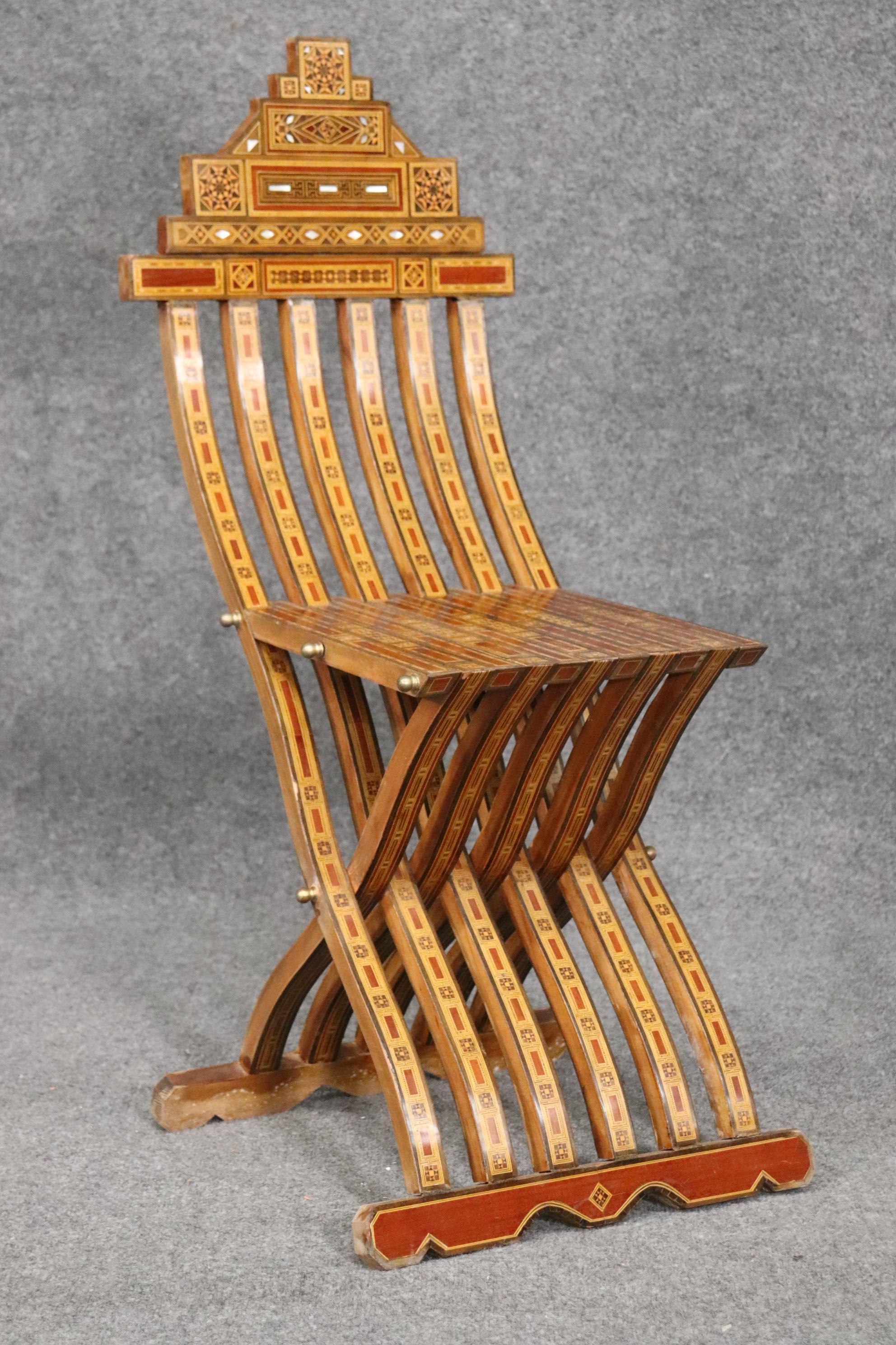 This is a fantastic Syrian inlaid folding chair. The chair is in very good condition and works fine. The chair measures 38 tall x 17 wide x 21 deep x seat height is 18 inches.