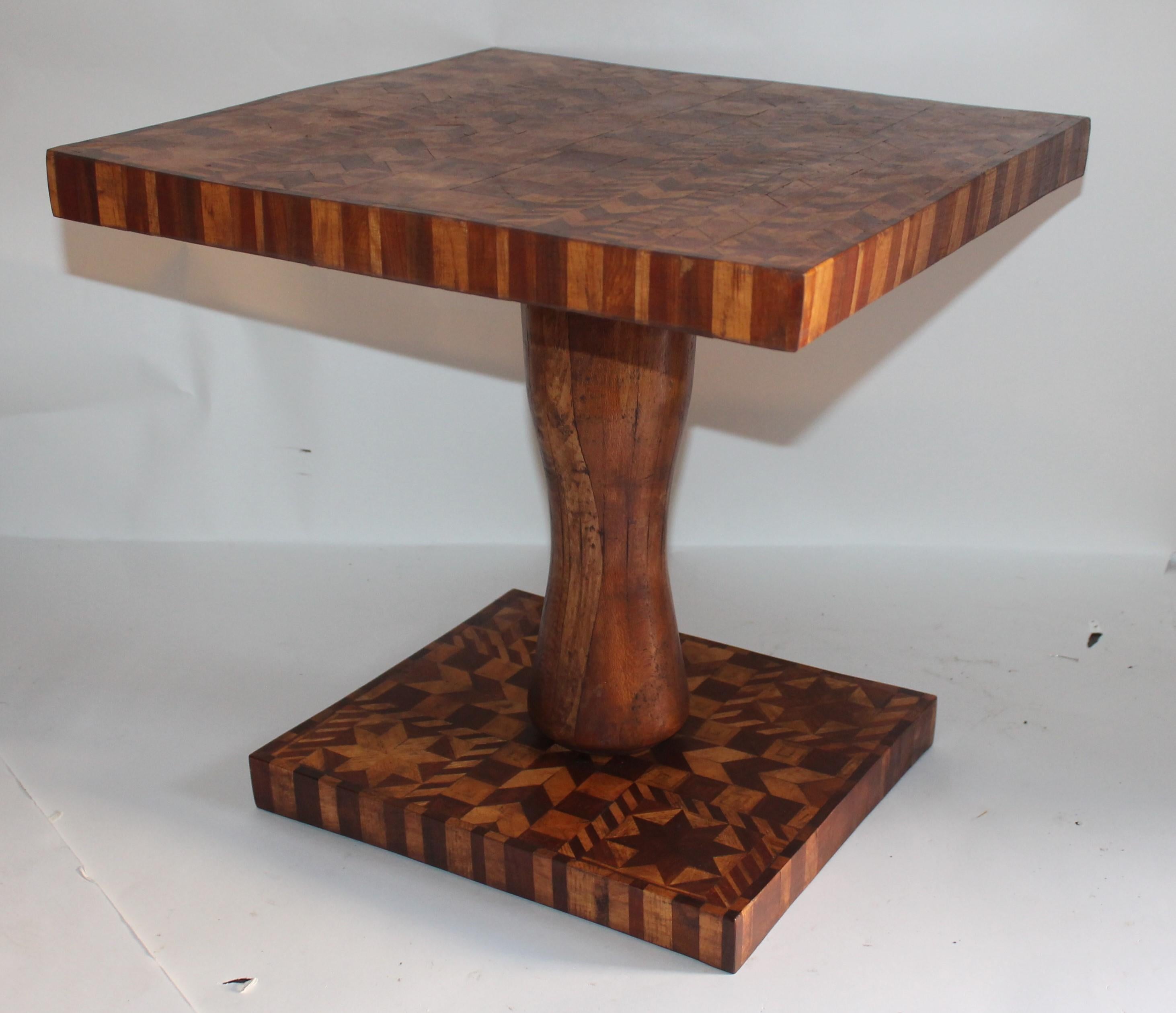 This unique folky marque table looks like a quilt pattern with stars and stripes. It is a pedestal table or a cute side table next to a club or wing chair.
