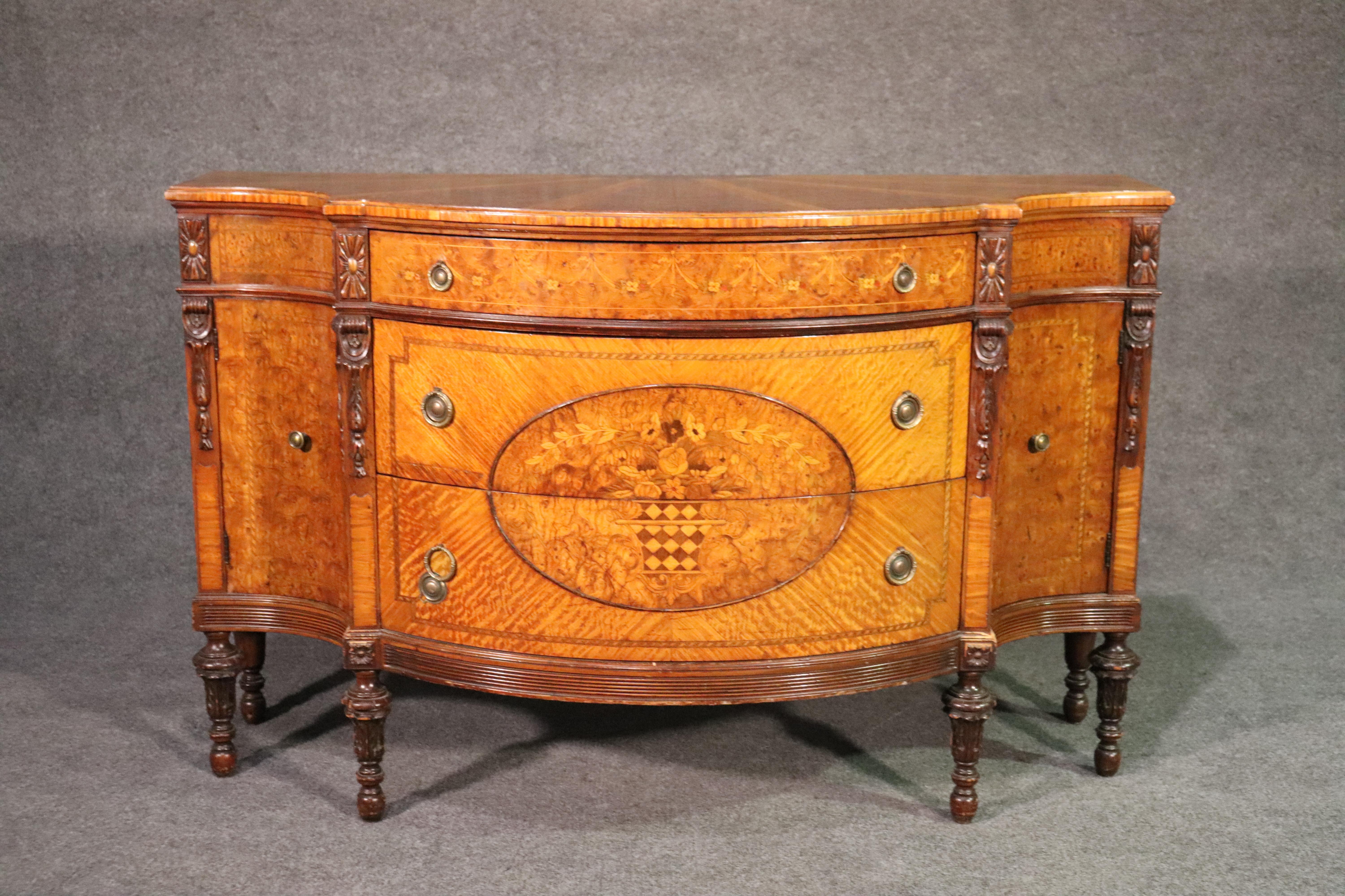This is a rather spectacular piece of furniture with breathtaking inlay of burled amboyna, olive and boxwood in a satinwood case. The case is absolutely stunning and you won't see another one of these anytime soon. The condition is also very good.