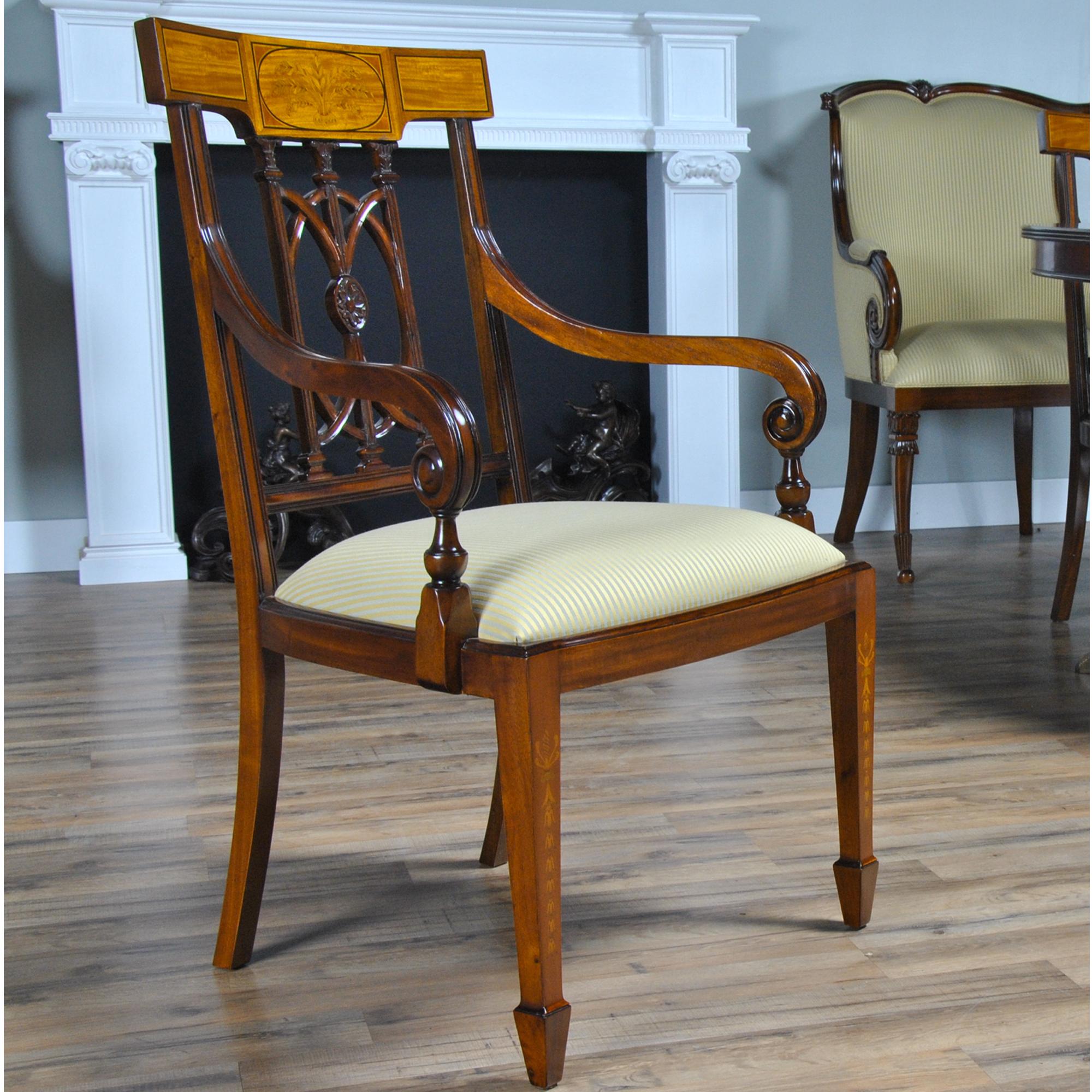 The Inlaid Hepplewhite Chairs, consisting of a set of ten chairs with 2 arm chairs and 8 side chairs. Each chair is decorated with hand inlaid panels across the crest rail, bellflower inlays along the front legs making these dining chairs an