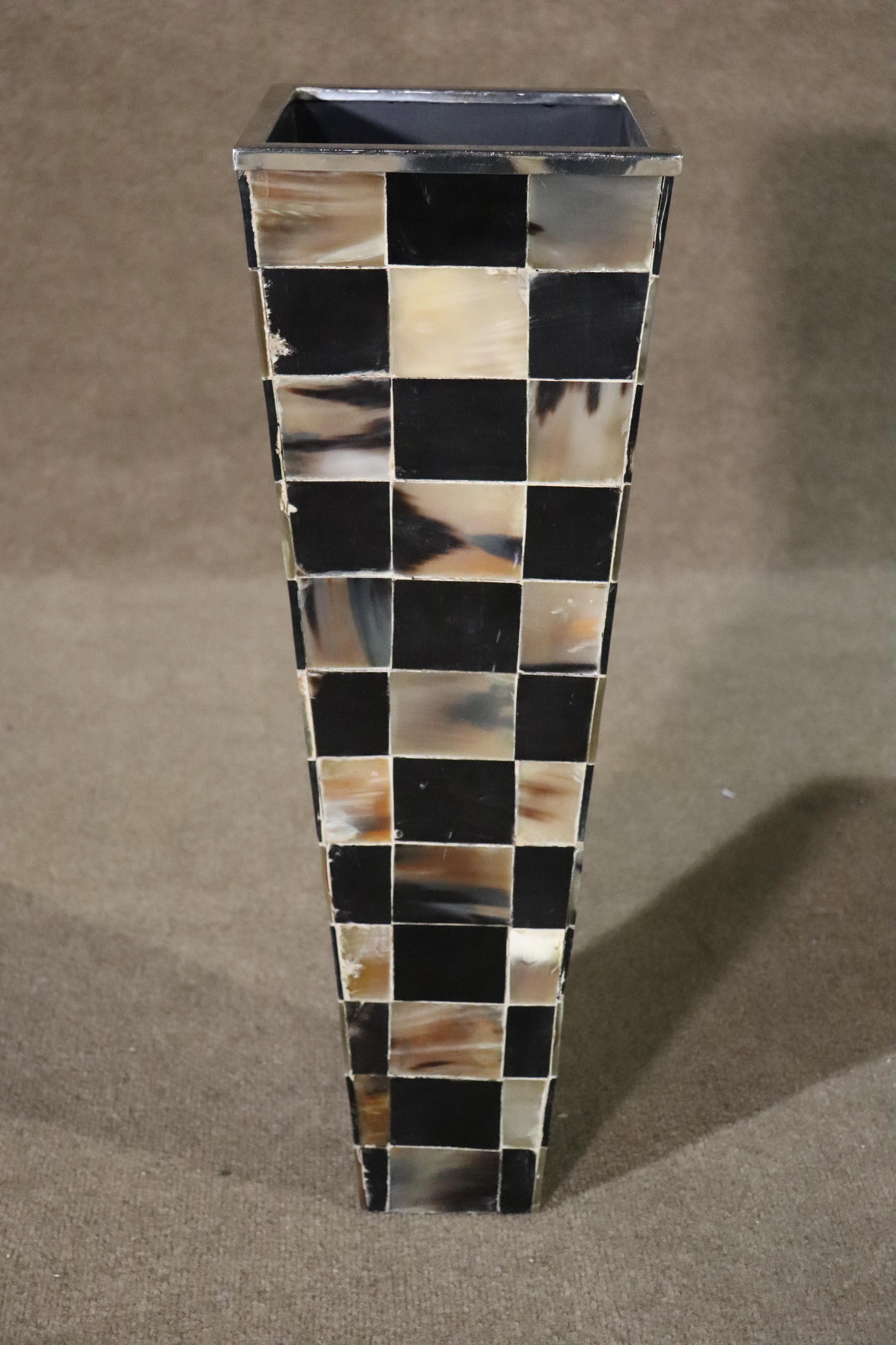 Decorative umbrella stand/vase with two tone checkerboard pattern. horn veneers on a wood tapering frame and chromed metal top rim.
Please confirm location NY or NJ
