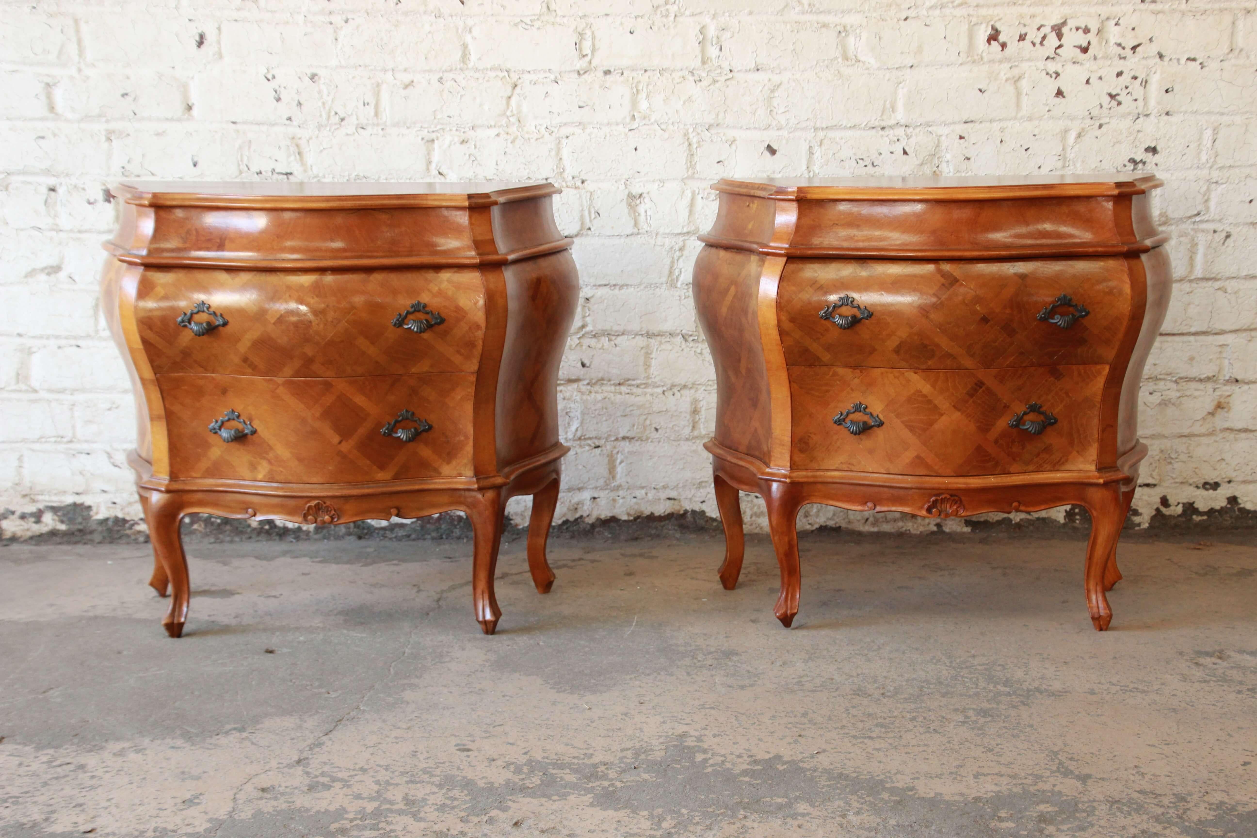 Offering an exceptional pair of parquetry inlaid Italian Bombay chest nightstand. The pair of chests have a beautiful parquetry inlaid design and are finished on the back sides. Both feature two large drawers for ample storage with shell designed