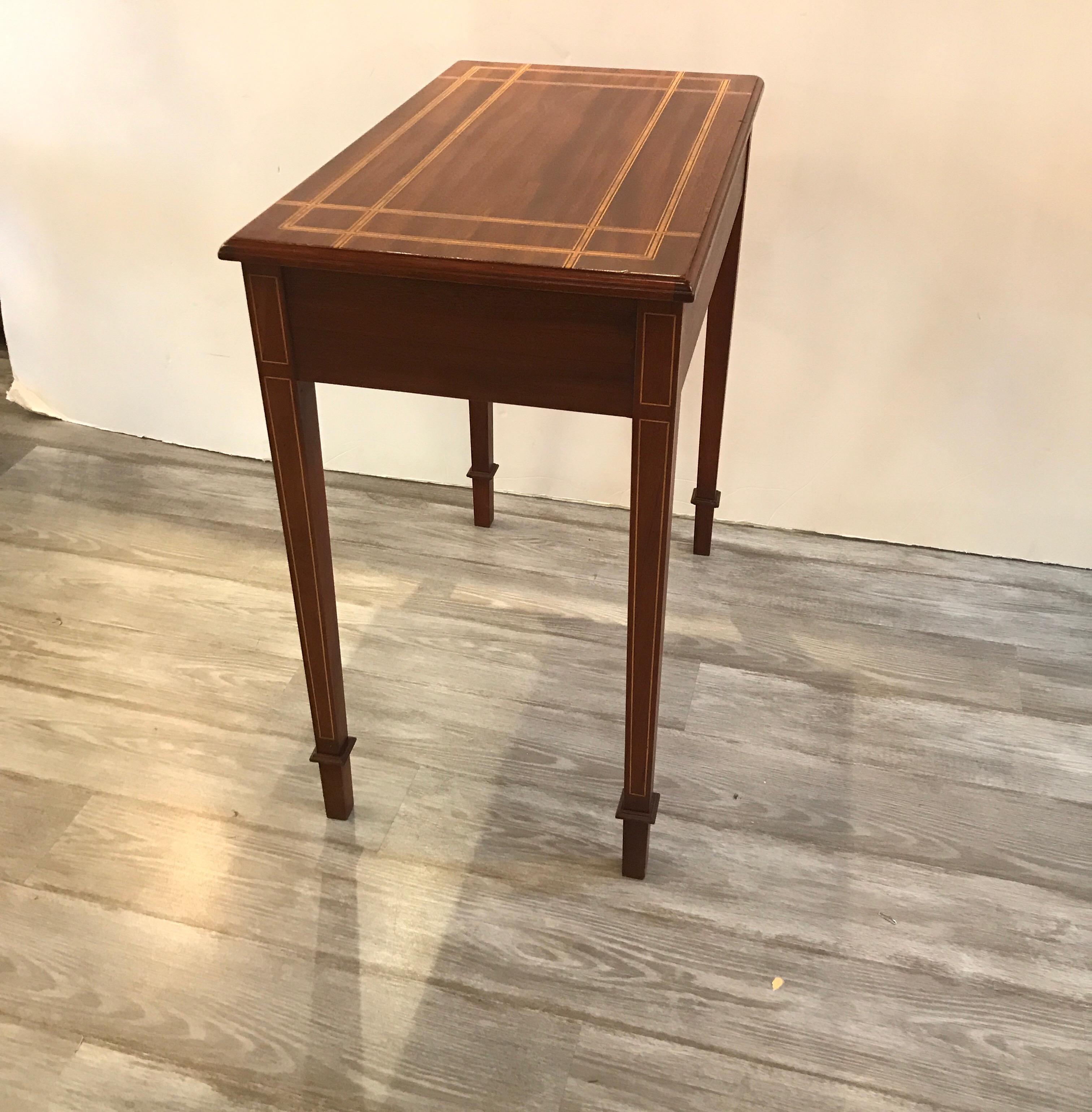 A diminutive mahogany console with drawer. The top with double inlaid border in satinwood. Perfect small writing table or side console