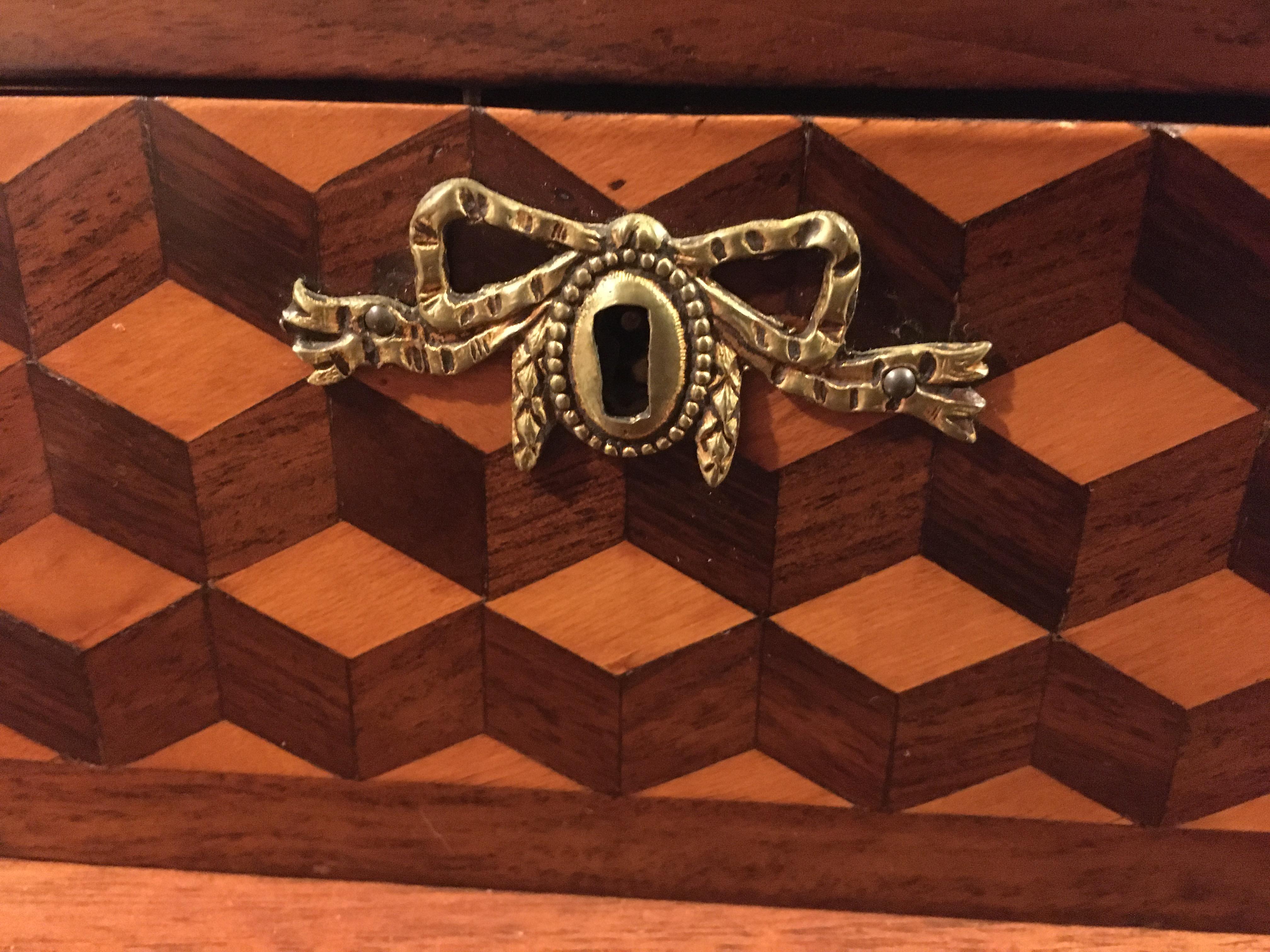 An inlaid mahogany dome tea caddy with brass tops inside.