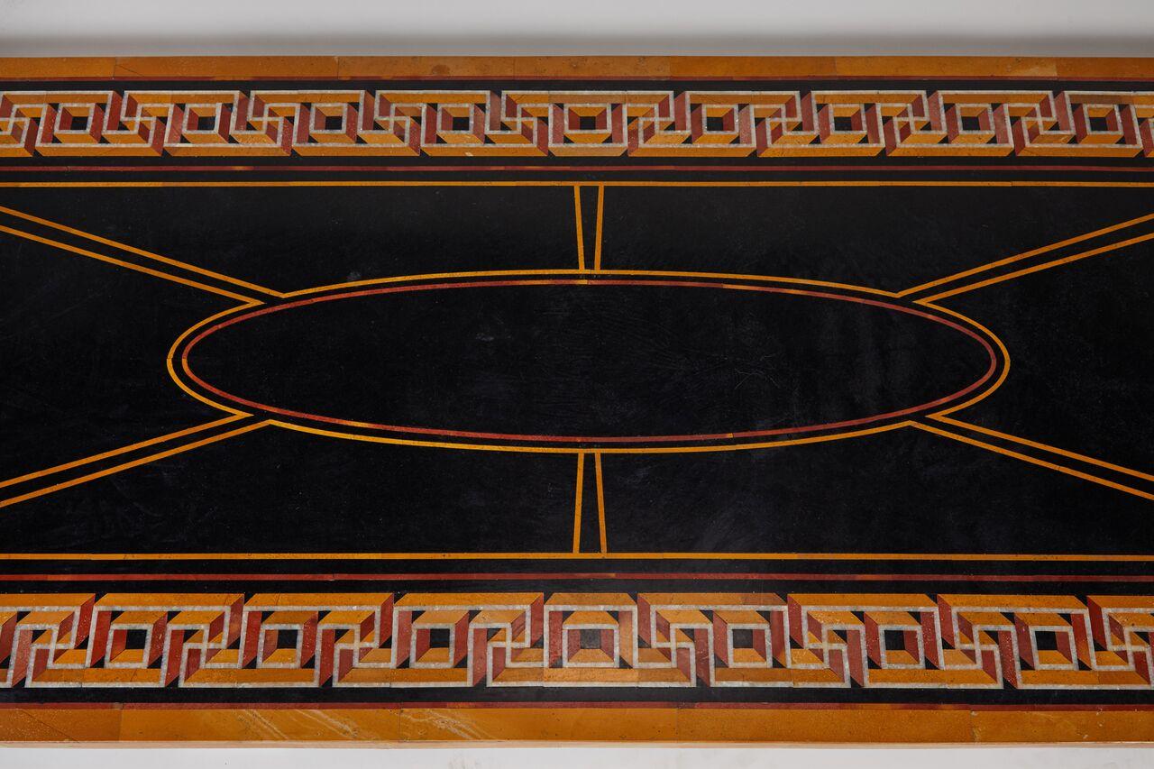Inlaid marble tabletop with stunning inlaid Greek key border. This piece could work well in both traditional and modern spaces.
